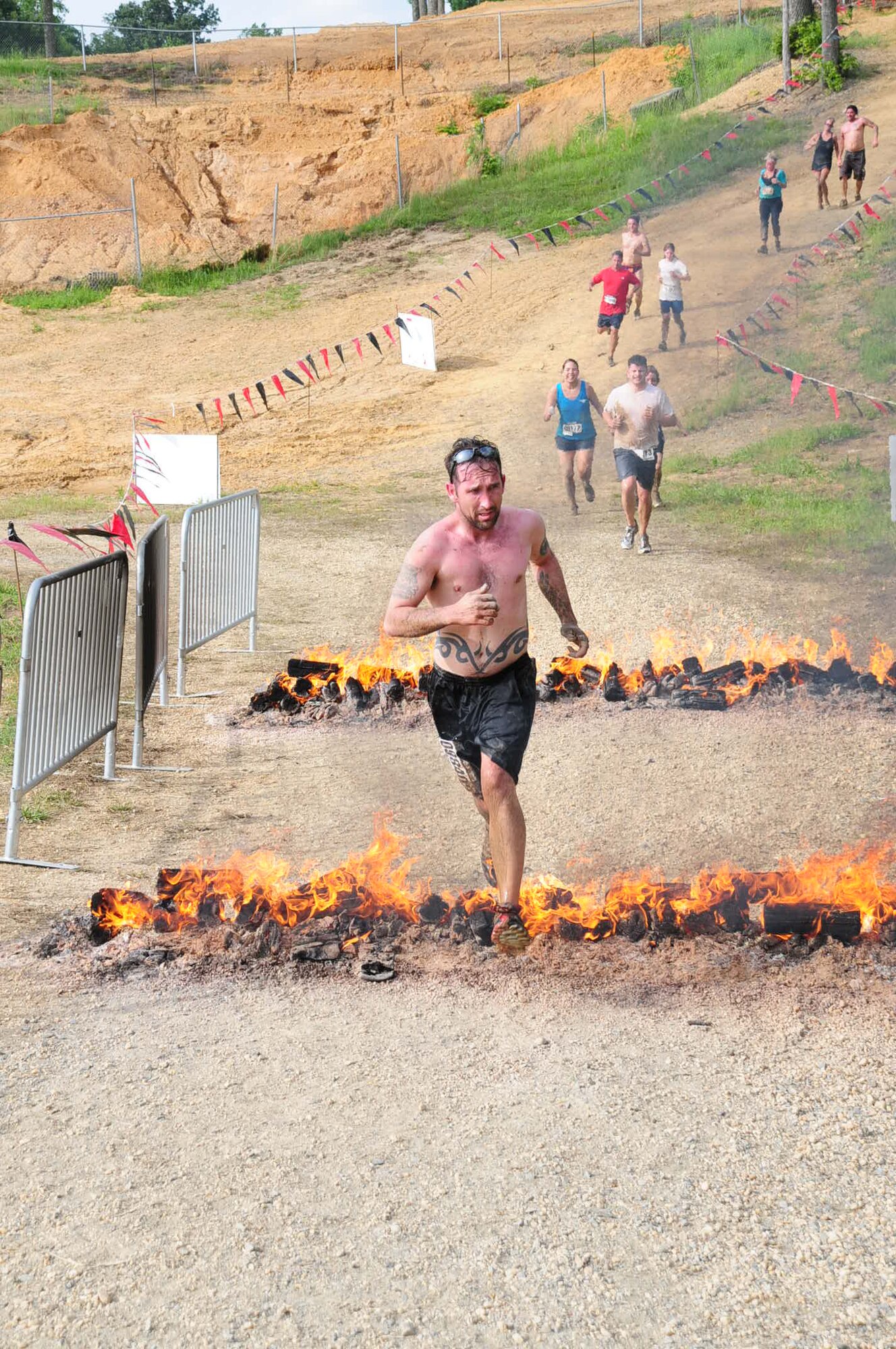MECHANICSVILLE, Md. -- Staff Sgt. Dempsey Anderson, 459th Maintenance Squadron, leaps over a row of flames during the three-mile Warrior Dash here May 21. The Warrior Dash is a nationwide extreme race that pits thousands of racers against military-style obstacles like wooden wall climbs and staggered logs. The dash also has unique features like a mud-covered slide and rusted automobile wreckage to traverse. Airmen from the 459th Air Refueling Wing participated in this year's race along with over 8,700 competitors during the Saturday race. (Submitted photo)
