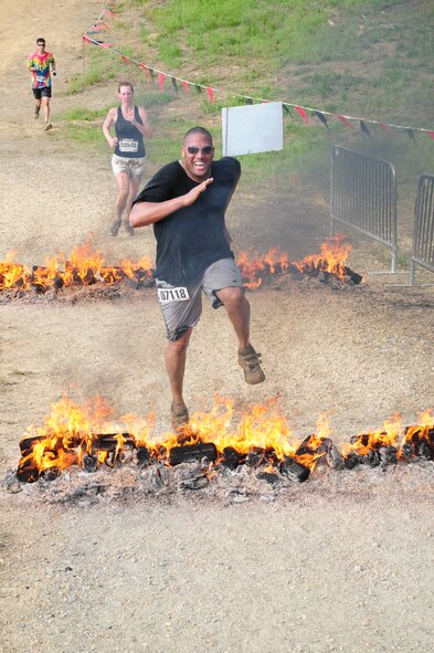 MECHANICSVILLE, Md. -- Senior Airman Lance Horne, 459th Maintenance Squadron, leaps over a row of flames during the three-mile Warrior Dash here May 21. The Warrior Dash is a nationwide extreme race that pits thousands of racers against military-style obstacles like wooden wall climbs and staggered logs. The dash also has unique features like a mud-covered slide and rusted automobile wreckage to traverse. Airmen from the 459th Air Refueling Wing participated in this year's race along with over 8,700 competitors during the Saturday race. (Submitted photo)