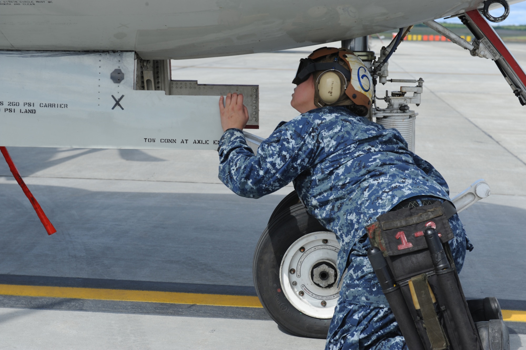 JOINT BASE ELMENDORF RICHARDSON, Alaska -- U.S. Navy Aviation Electronics Technician Airman Lisa Abel performs pre-flight maintenance checks during Exercise Northern Edge 11 in JBER, Alaska, June 16, 2011. Northern Edge, Alaska's largest military training exercise, is designed to prepare joint forces to respond to crises throughout the Asia-Pacific region. (Photo by Mass Communication Specialist 2nd Class Rufus Hucks)