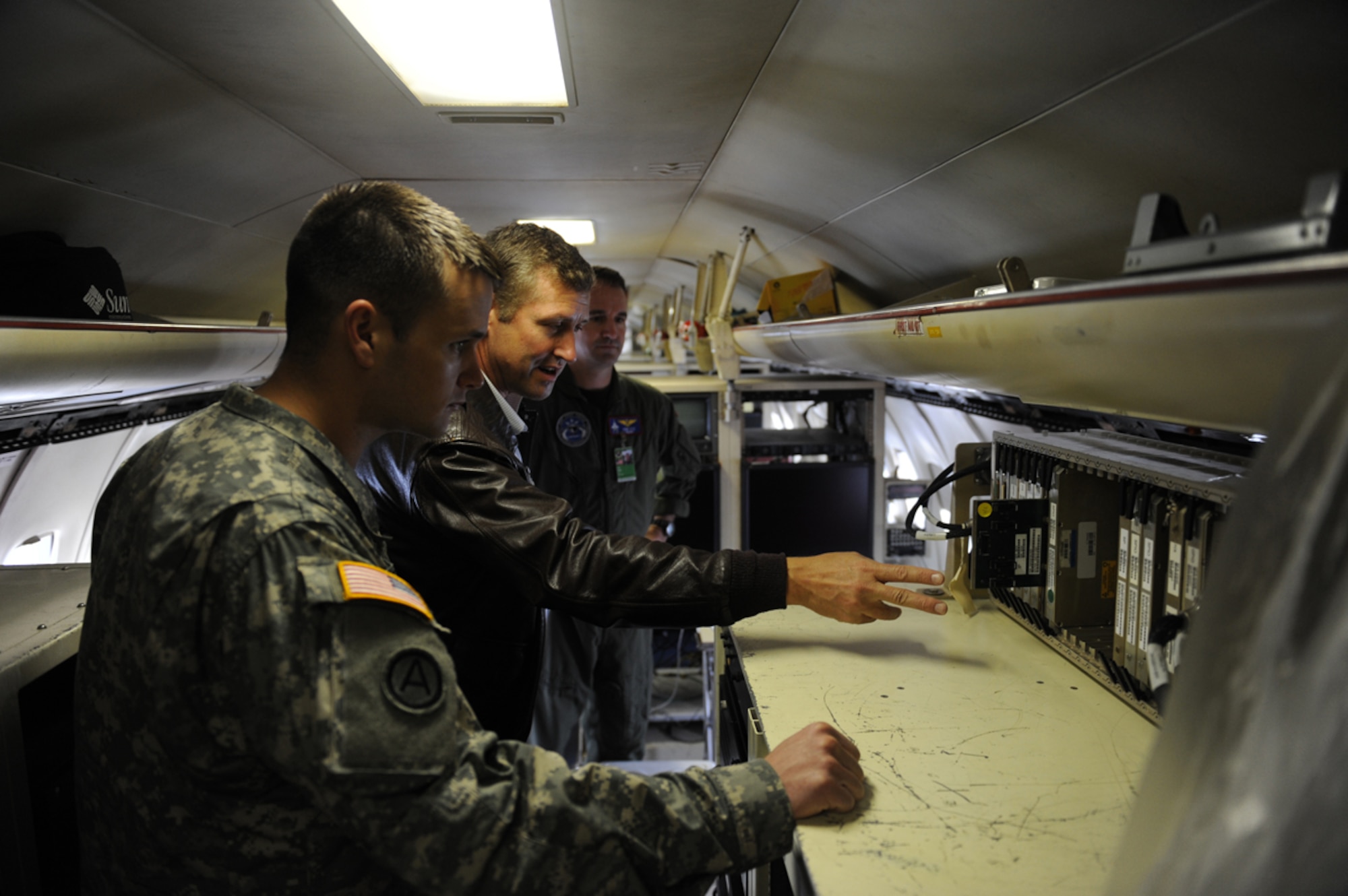 JOINT BASE ELMENDORF RICHARDSON, Alaska --  U.S. Army Capt. Charles Spears (front) listens as Pete Bartos (center) and U.S. Navy Cmdr. Erik Etz (back) discuss the capabilities of the F-35 Joint Strike fighter sensor in JBER, Alaska, June 14, 2011. The sensor was brought to Alaska for testing during Exercise Northern Edge 11, Alaska's largest military training exercise. The exercise is designed to prepare joint forces to respond to crises throughout the Asia-Pacific region. (Photo by Mass Communication Specialist 2nd Class Rufus Hucks)