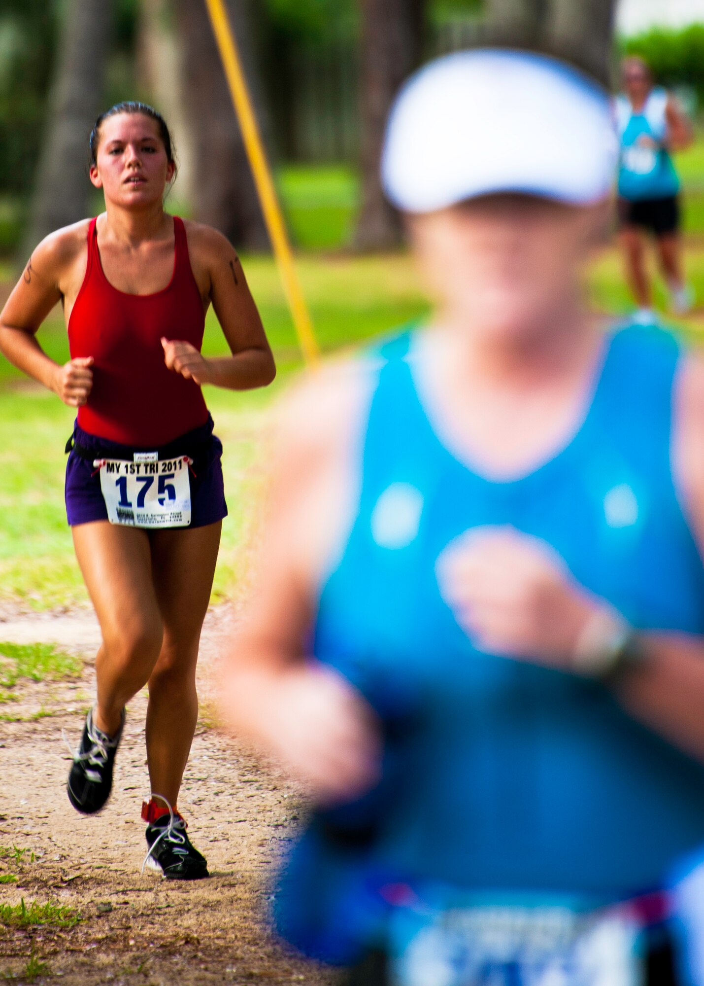 Runners move toward the final turn at this year’s “My First Tri” triathlon at Eglin Air Force Base Fla., June 18.  Almost 350 people of all ages “tried” at the 12th annual event.  The triathlon consists of a 200-meter swim, eight-mile bike ride, then a 2.5-mile run.  (U.S. Air Force photo/Samuel King Jr.)