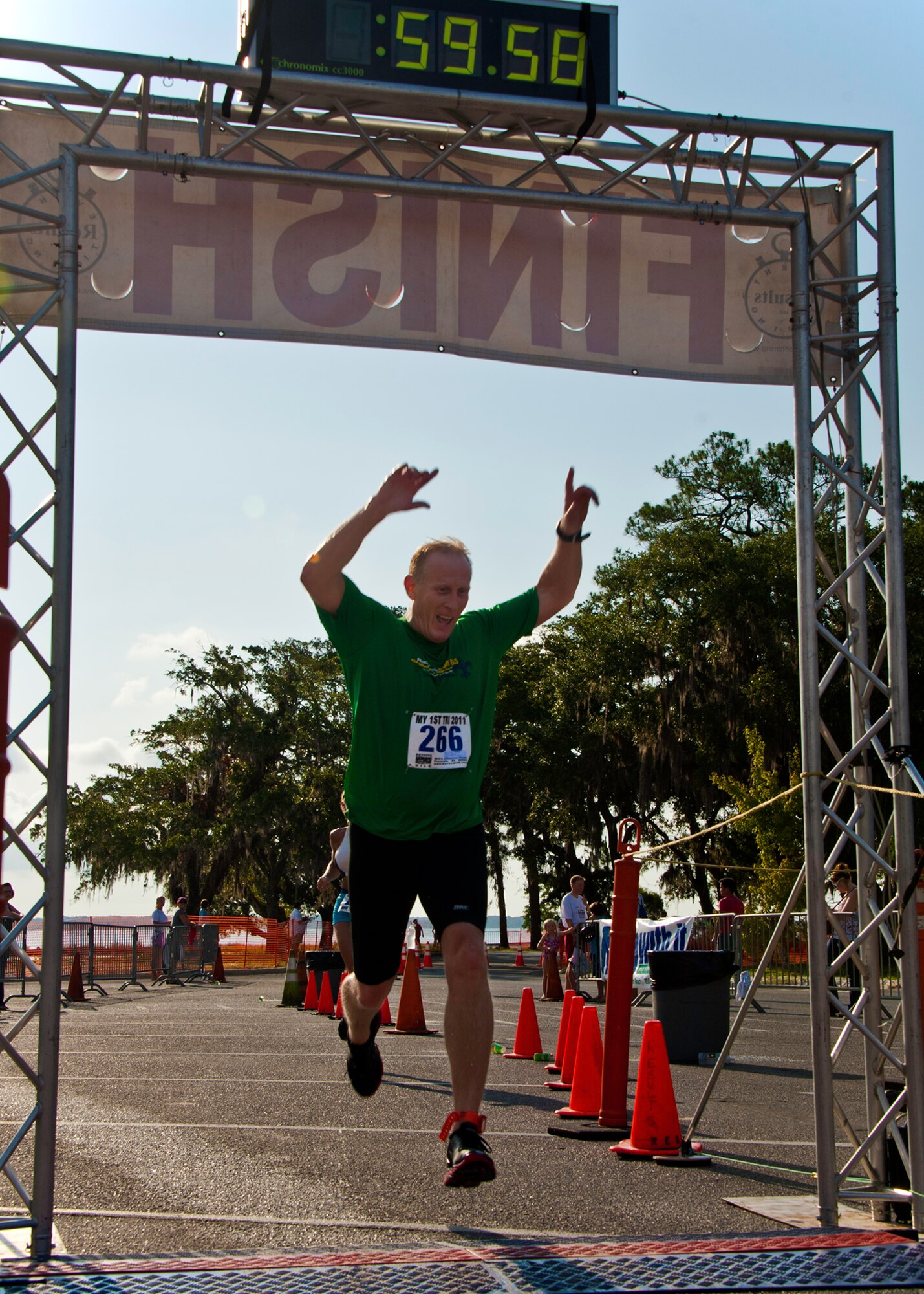 Steve Rogers leaps across the finish line at this year’s “My First Tri” triathlon at Eglin Air Force Base Fla., June 18.  Almost 350 people of all ages “tried” at the 12th annual event.  The triathlon consists of a 200-meter swim, eight-mile bike ride, then a 2.5-mile run.  Rogers was 78th overall for alumni at 59 minutes and 59 seconds.  (U.S. Air Force photo/Samuel King Jr.)