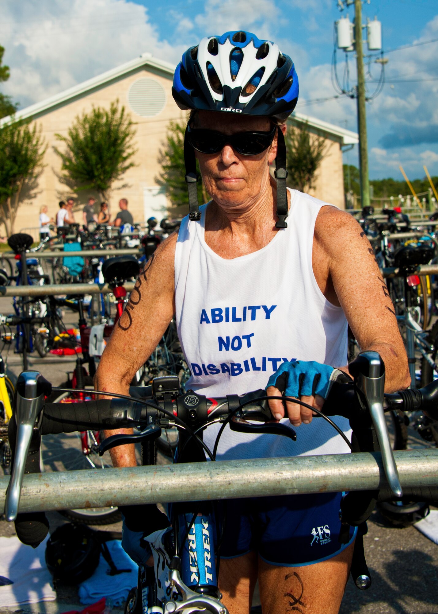 Mary Newcomer, age 67, places her bike on a rack before beginning the run portion of this year’s “My First Tri” triathlon at Eglin Air Force Base Fla., June 18.  Almost 350 people of all ages “tried” at the 12th annual event.  The triathlon consists of a 200-meter swim, eight-mile bike ride, then a 2.5-mile run.  Newcomer completed her 14th triathlon in an hour and 46 minutes.  (U.S. Air Force photo/Samuel King Jr.)