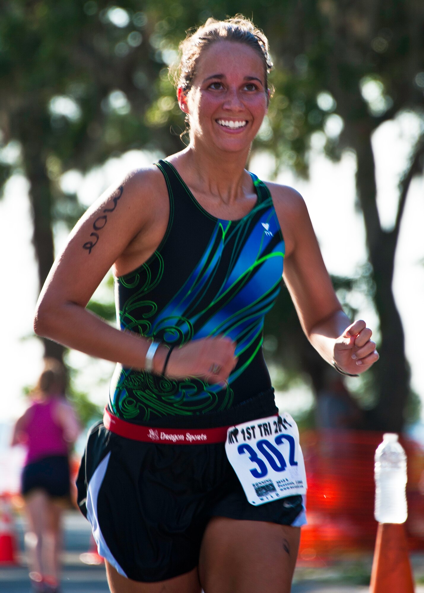 Karynn Sutherlin, 46th Test Wing, looks up at the clock as she heads to the finish line of this year’s “My First Tri” triathlon at Eglin Air Force Base Fla., June 18.  Almost 350 people of all ages “tried” at the 12th annual event.  The triathlon consists of a 200-meter swim, eight-mile bike ride, then a 2.5-mile run.  Sutherlin was 33rd overall for alumni and first in her alumni age group finishing at 51 minutes and 59 seconds.  (U.S. Air Force photo/Samuel King Jr.)