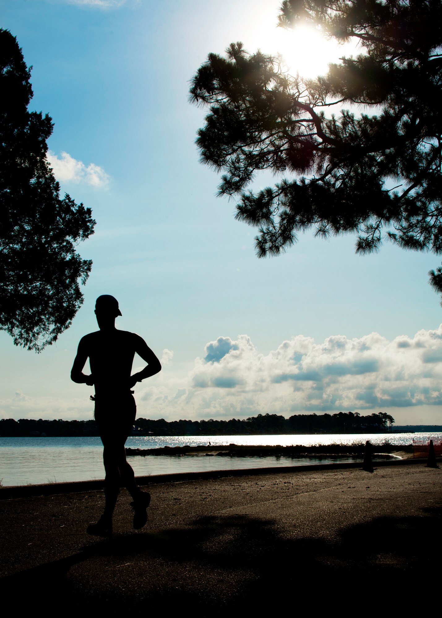 A runner heads toward the finish with less than 100 yards to go at this year’s “My First Tri” triathlon at Eglin Air Force Base Fla., June 18.  Almost 350 people of all ages “tried” at the 12th annual event.  The triathlon consists of a 200-meter swim, eight-mile bike ride, then a 2.5-mile run.  David Shearon finished with the best overall time - 39 minutes 24 seconds.  Wendy Ewing had the best time for females with 47 minutes 39 seconds.  (U.S. Air Force photo/Samuel King Jr.)