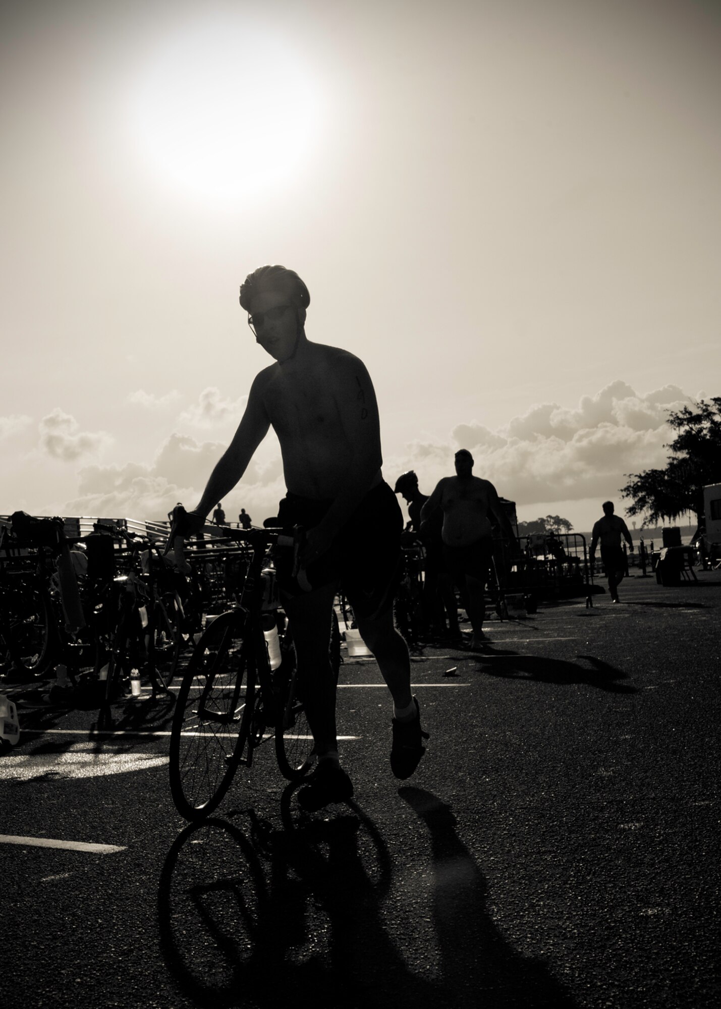 Peter Lennox, 96th Medical Operations Squadron, rolls his bike to the starting line after completing the swim portion at this year’s “My First Tri” triathlon at Eglin Air Force Base Fla., June 18.  Almost 350 people of all ages “tried” at the 12th annual event.  The triathlon consists of a 200-meter swim, eight-mile bike ride, then a 2.5-mile run.  Lennox was 20th overall among first-time competitors finishing at 56 minutes and 47 seconds. (U.S. Air Force photo/Samuel King Jr.)