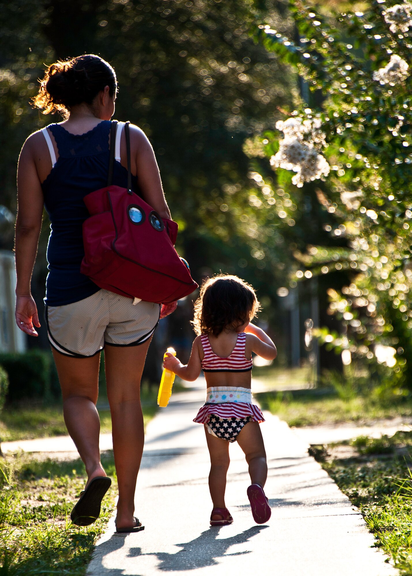 A mother and daughter watch as bikes wiz by during this year’s “My First Tri” triathlon at Eglin Air Force Base Fla., June 18.  Almost 350 people of all ages “tried” at the 12th annual event.  The triathlon consists of a 200-meter swim, eight-mile bike ride, then a 2.5-mile run.  David Shearon finished with the best overall time - 39 minutes 24 seconds.  Wendy Ewing had the best time for females with 47 minutes 39 seconds.  (U.S. Air Force photo/Samuel King Jr.)