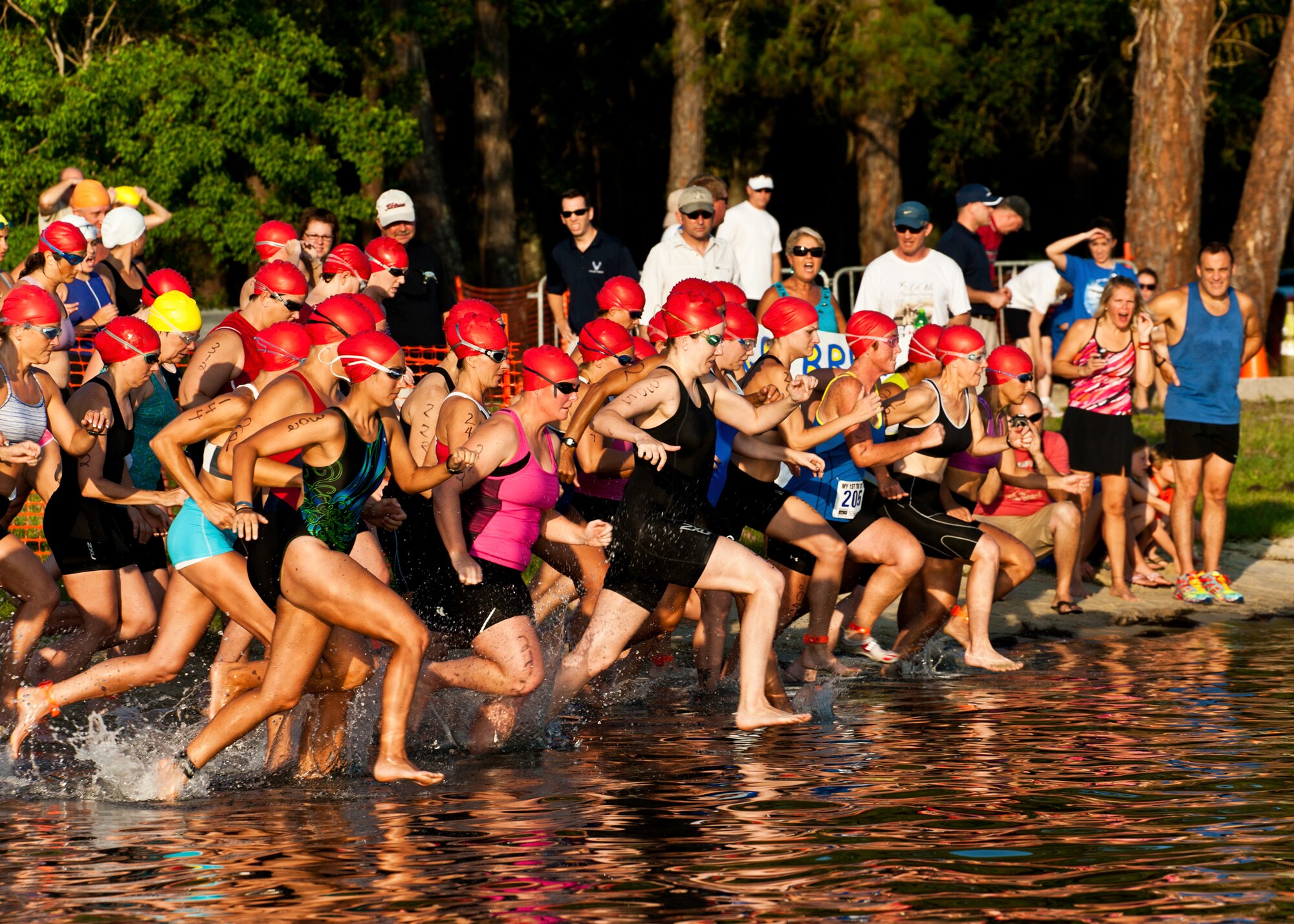The women’s group race into the water at this year’s “My First Tri” triathlon at Eglin Air Force Base Fla., June 18.  Almost 350 people of all ages “tried” at the 12th annual event.  The triathlon consists of a 200-meter swim, eight-mile bike ride, then a 2.5-mile run.  David Shearon finished with the best overall time - 39 minutes 24 seconds.  Wendy Ewing had the best time for females with 47 minutes 39 seconds. (U.S. Air Force photo/Samuel King Jr.)