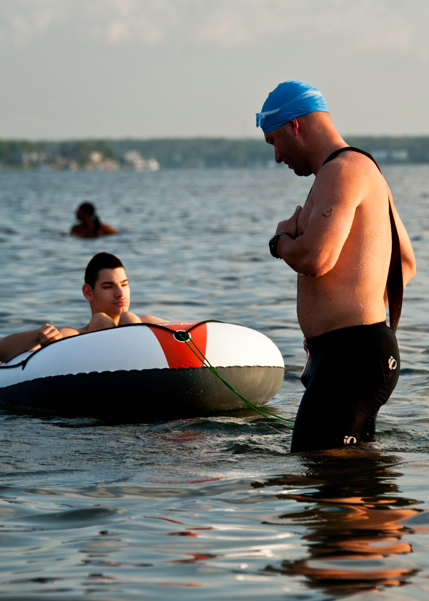 Matthew Hartz, 16th Electronic Warfare Squadron, and his son Gage prepare for the first leg of the 12th Annual “My First Tri” triathlon at Eglin Air Force Base Fla., June 18.  Hartz pulls his son behind him during the swim portion and pushes him in a custom built cart during the run portion.  The father and son team finished 103 overall for alumni at one hour and five minutes.  The Hartzs have also completed two half-marathons together.  Almost 350 people of all ages “tried” at the 12th annual event.  The triathlon consists of a 200-meter swim, eight-mile bike ride, then a 2.5-mile run.  (U.S. Air Force photo/Samuel King Jr.)
