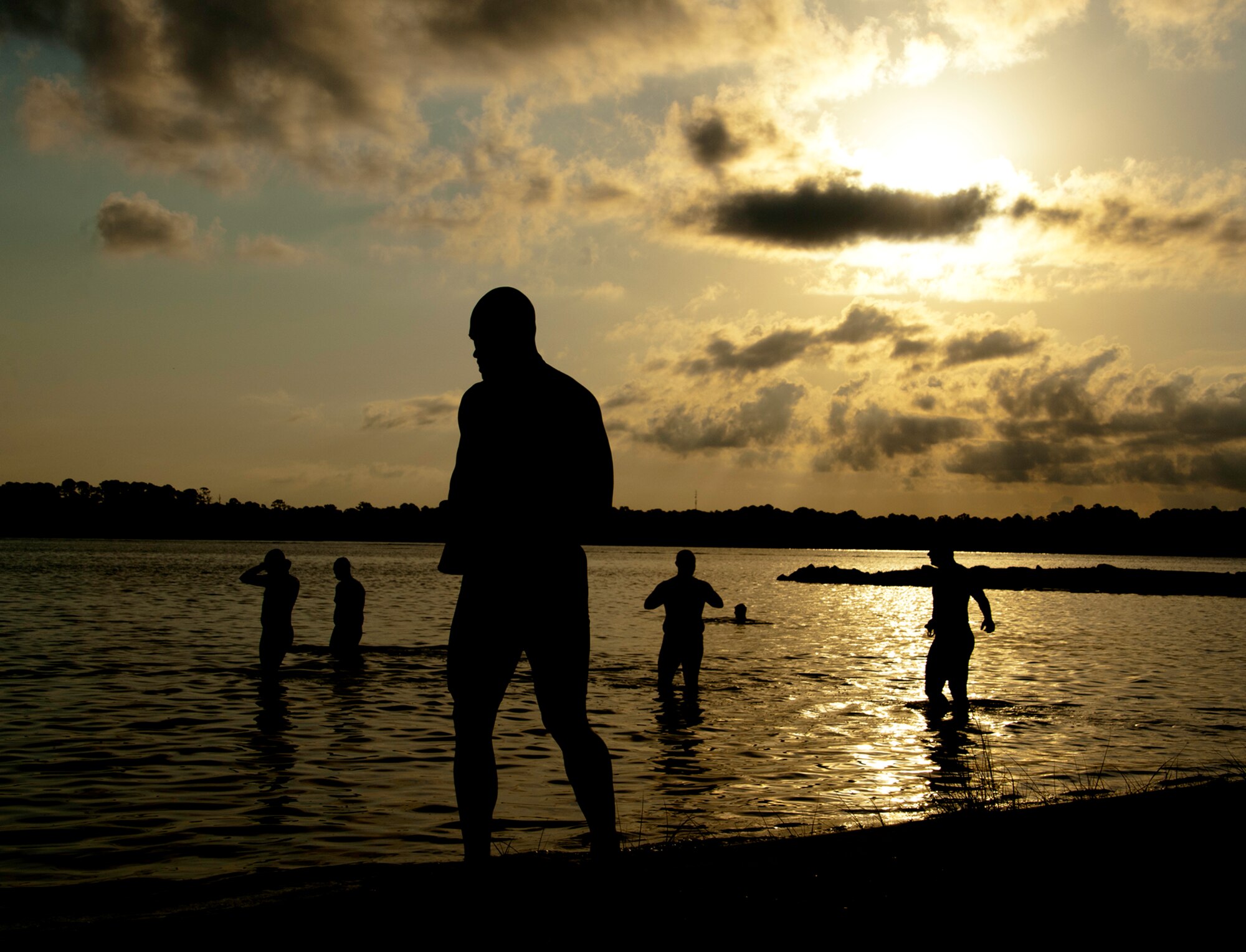 Participants test the waters of Eglin’s Post’l Point before they begin this year’s “My First Tri” triathlon June 18.  Almost 350 people of all ages “tried” at the 12th annual event.  The triathlon consists of a 200-meter swim, eight-mile bike ride, then a 2.5-mile run.  David Shearon finished with the best overall time - 39 minutes 24 seconds.  Wendy Ewing had the best time for females with 47 minutes 39 seconds.  (U.S. Air Force photo/Samuel King Jr.)