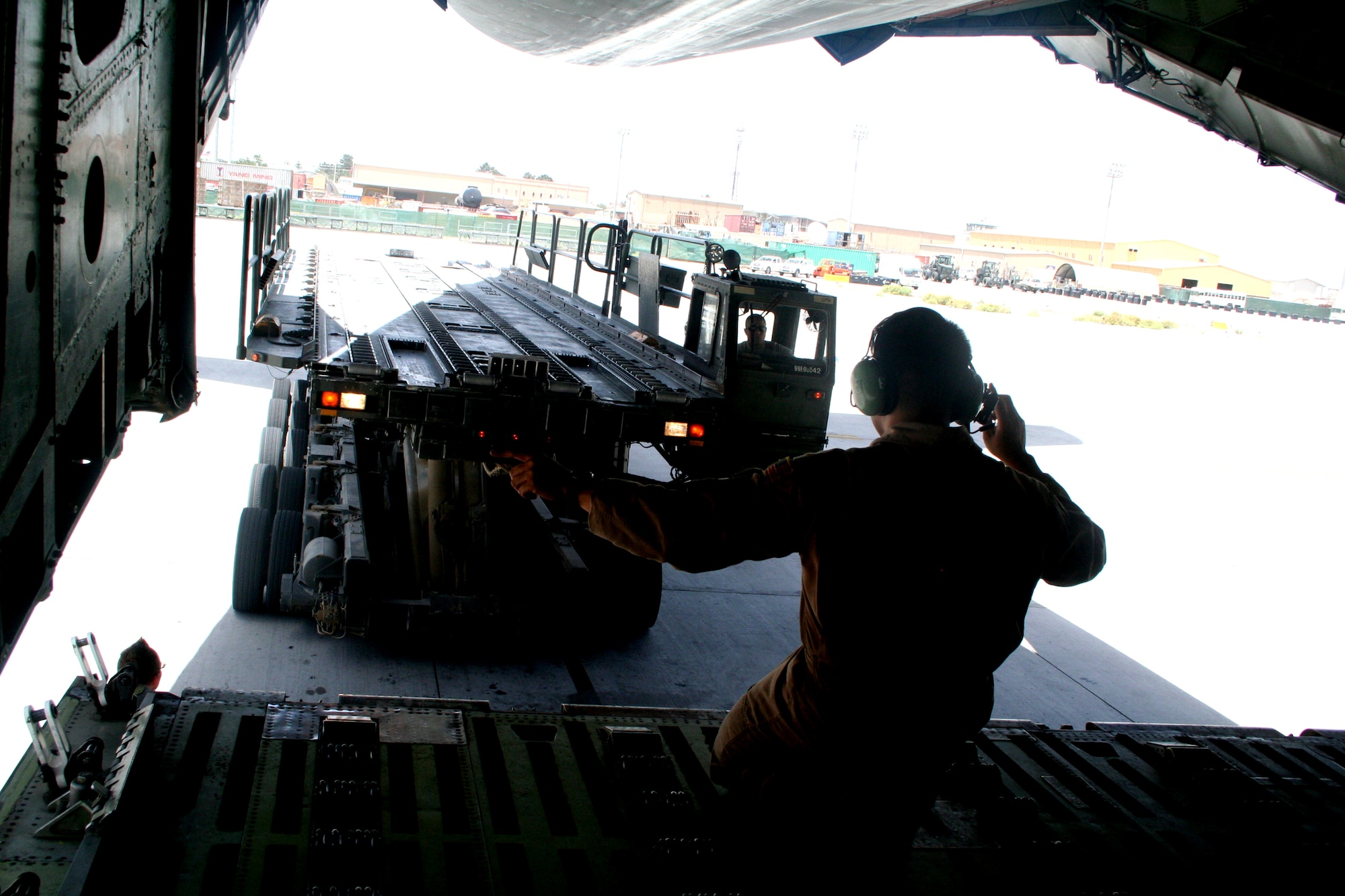 Staff Sgt. Angelo Dumanhog, C-5 Galaxy loadmaster, works near a C-5M Super Galaxy on June 6, 2011, at Bagram Airfield, Afghanistan. He was doing his work after being a part of the aircrew who completed the first direct delivery airlift mission through the Arctic Circle from Dover Air Force Base, Del., to Bagram Airfield June 5-6, 2011. Sergeant Dumanhog was one of 14 crewmembers who flew the mission. He is from the 9th Airlift Squadron at Dover AFB and his hometown is Lemoore, Calif.  (U.S. Air Force Photo/Master Sgt. Scott T. Sturkol)