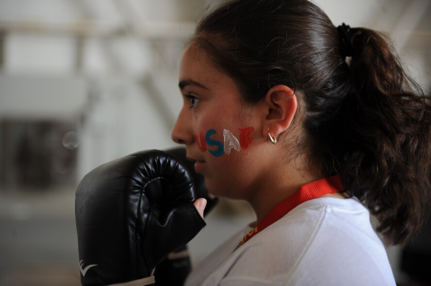 DYESS AIR FORCE BASE, Texas--Pricila Sanchez, sister to Airman Nancy Kasberg, 7th Bomb Wing Public Affairs, practices kick boxing techniques June 17 during Operation Dyess Kids here. The Airman & Family Readiness Center hosted the 8th annual Operation Dyess Kids event to give children of servicemembers the opportunity to see a "fun" version of a deployment. More than 250 Dyess children participated in the mock deployment, which included a military processing line, physical training session, boarding a C-130 as well as a “welcome home celebration.” (U.S. Air Force photo by Airman 1st Class Jonathan Stefanko/ Released)