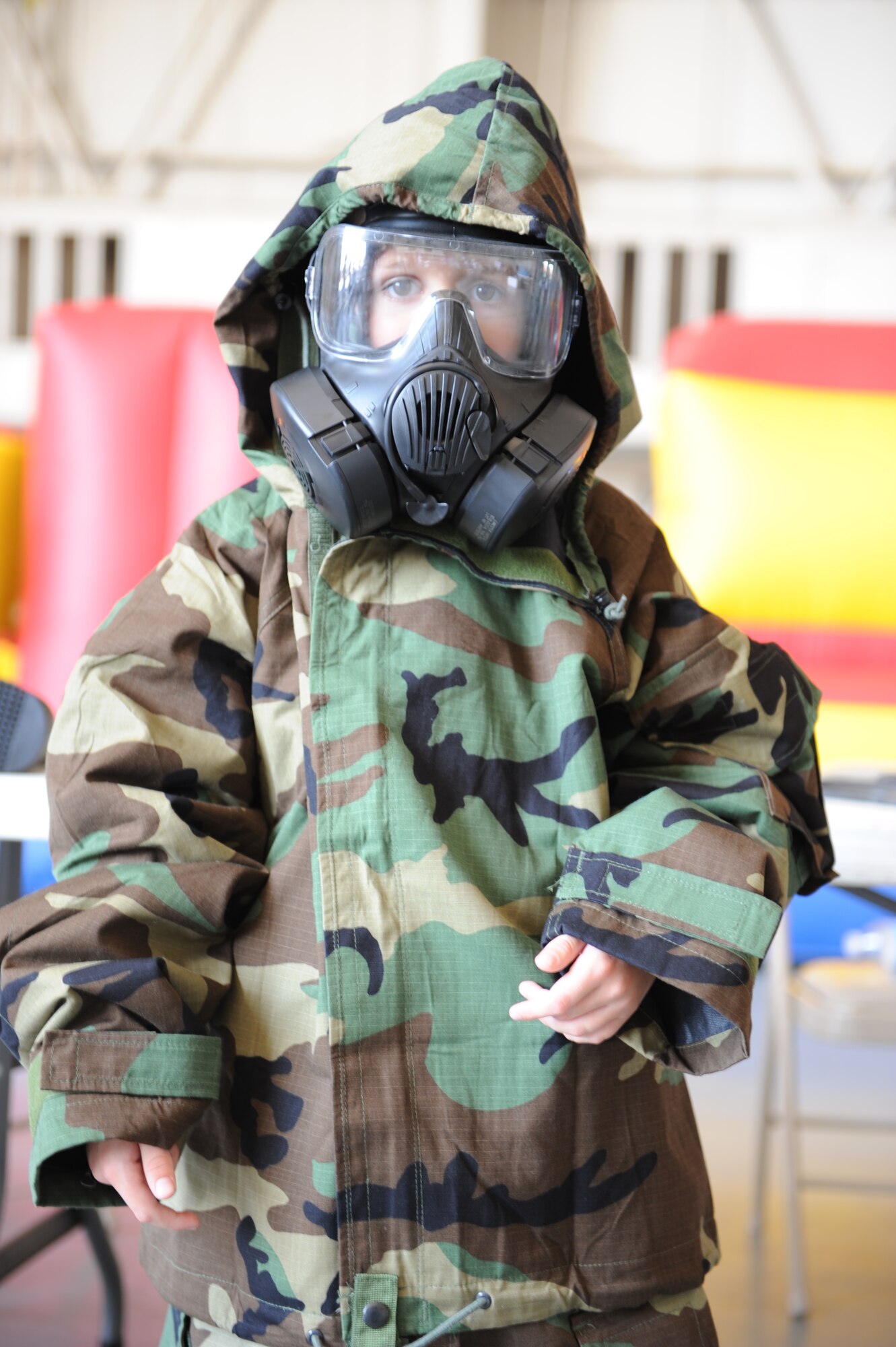 DYESS AIR FOCE BASE, Texas—The child of a Dyess Airman tries on Mission Oriented Protective Posture gear June 17 during Operation Dyess Kids here. The Airman & Family Readiness Center hosted the 8th annual Operation Dyess Kids event to give children of servicemembers the opportunity to see a "fun" version of a deployment. More than 250 Dyess children participated in the mock deployment, which included a military processing line, physical training session, boarding a C-130 as well as a “welcome home celebration.” (U.S. Air Force photo by Airman 1st Class Jonathan Stefanko/ Released)