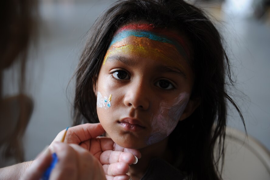 A child of a Dyess Airman gets her face painted June 17 during Operation Dyess Kids here. The Airman & Family Readiness Center hosted the 8th annual Operation Dyess Kids event to give children of servicemembers the opportunity to see a "fun" version of a deployment. More than 250 Dyess children participated in the mock deployment, which included a military processing line, physical training session, boarding a C-130 as well as a “welcome home celebration.” (U.S. Air Force photo by Airman 1st Class Jonathan Stefanko/ Released)