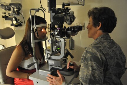 Lauren Arrisola (left), A Randolph AFB dependent,has her eyes examined by Lt. Col. Christine Stabile, 359th Aerospace-Medicine  Squadron Optometry Flight commander, at Randolph AFB June 16  (U.S. Air Force photo/Airman Alexis Siekert) (released)