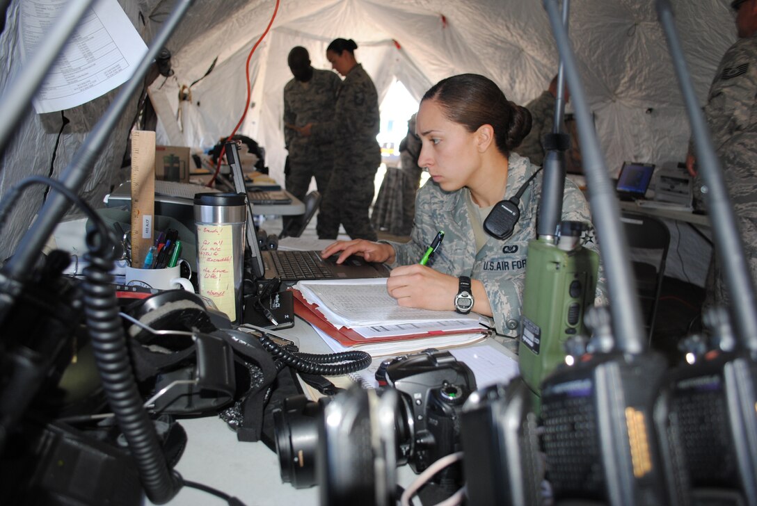 Staff Sgt. Brenda Davis monitors her computer screen and annotates information on various logs in the 433rd Contingency Response Element’s temporary command and control center at Naval Auxiliary Landing Field, San Clemente Island, Calif., April 17, 2011, in support of Patriot Hook 2011.
  
Patriot Hook is a large-scale air mobility exercise involving Air Force Reserve Command airlift control flights, flying units and aerial port personnel. Throughout the exercise, participants conduct deployment-type operations from three primary locations California; North Island Naval Air Station, Point Mugu and Naval Auxiliary Landing Field San Clemente Island. (U.S. Air Force photo/Senior Airman Luis Loza Gutierrez)