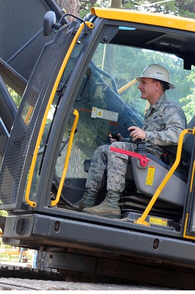 Col. Tim Fay, 2nd Bomb Wing commander, demolishes a home in the Capehart Housing Area located on Barksdale Air Force Base, La., June 20. The homes in the Capehart community are being demolished and the area returned to nature; Colonel Fay was invited to help demolish the first of the homes, the rest will be torn-down over the next few months. (U.S. Air Force photo/Senior Airman Joanna M. Kresge)