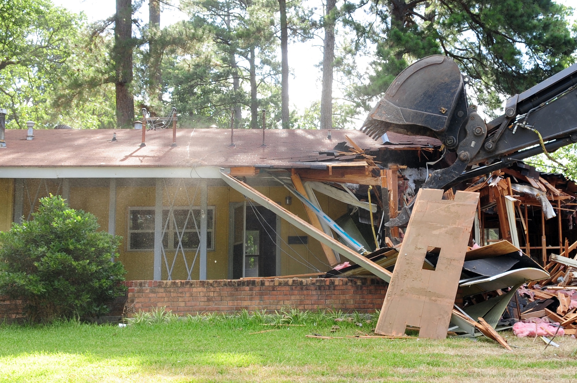 A home in the Capehart Housing Area is torn down by local contractors on the East Reservation of Barksdale Air Force Base, La., June 20. The homes in the Capehart community have been replaced by the 561 new homes in the Liberty Heights and Heritage Heights housing areas. (U.S. Air Force photo/Senior Airman Joanna M. Kresge)