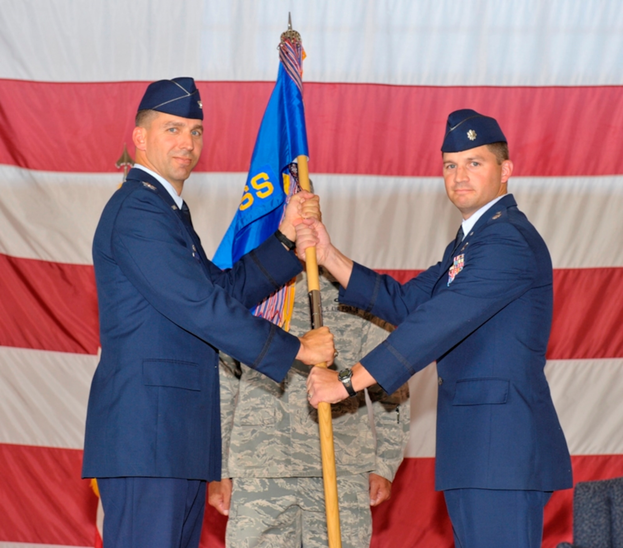 Colonel Wesley Hallman, 325th Operations Group commander, passes command of the 325th Operations Support Squadron to Lt. Col. David O'Malley during a change of command ceremony June 17.  Colonel O'Malley replaces Lt. Col. Bret Anderson who departs Tyndall to attend Air War College at Maxwell Air Force Base, Ala. Colonel O'Malley served at the 43rd Fighter Squadron as the director of operations since 2009. (U.S. Air Force photo by Jonathan Gibson)   