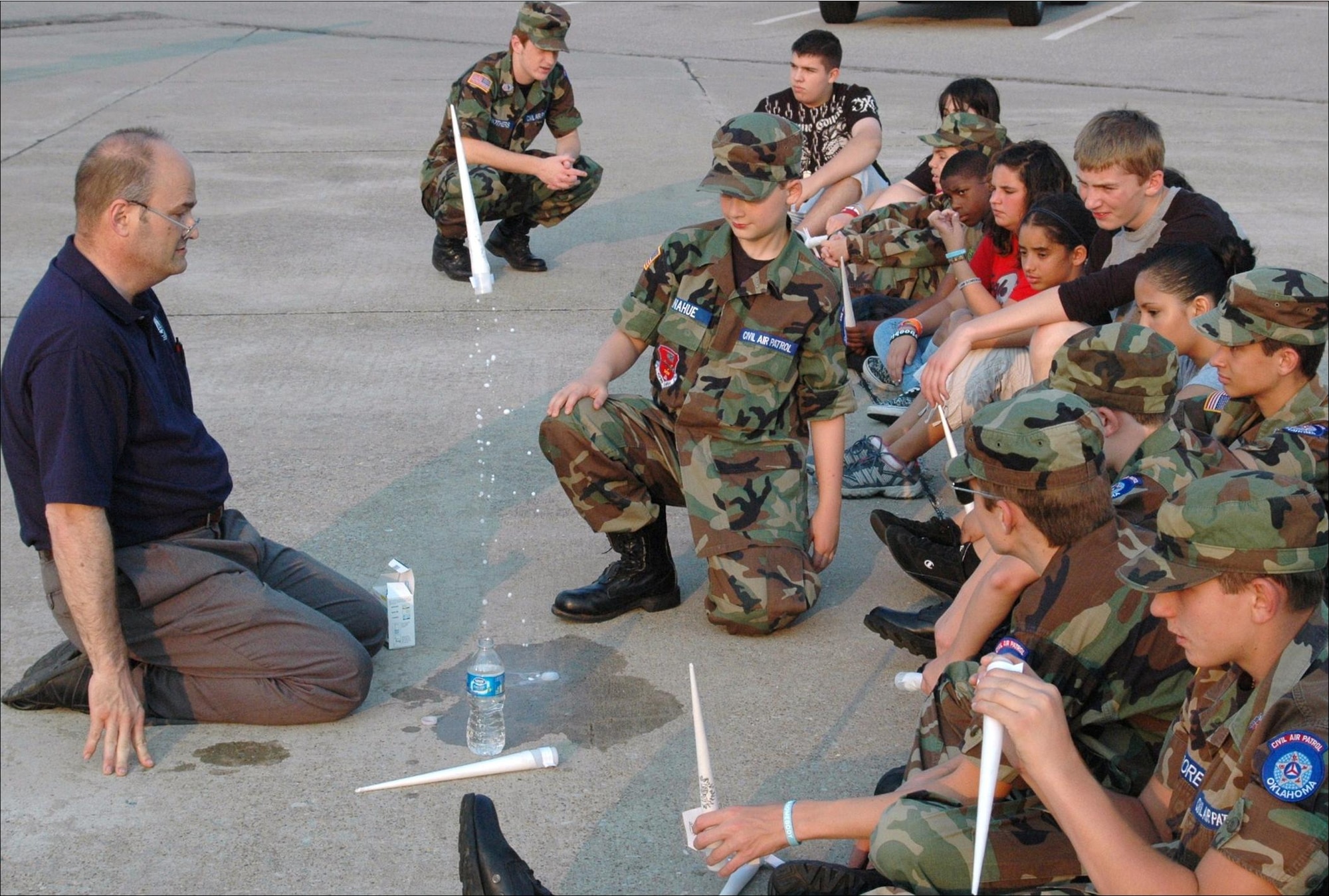 Capt. Liem Donahue, aerospace education instructor with the Civil Air Patrol’s Flying Castle Composite Squadron, worked with cadet members on the mechanics or chemistry of the Fizzy Flyer rocket. This was one of many aerospace projects planned for the CAP Cadets on June 7. For more information on Tinker’s CAP squadron, call 734-0640. (Air Force photo by Kathy Paine)

