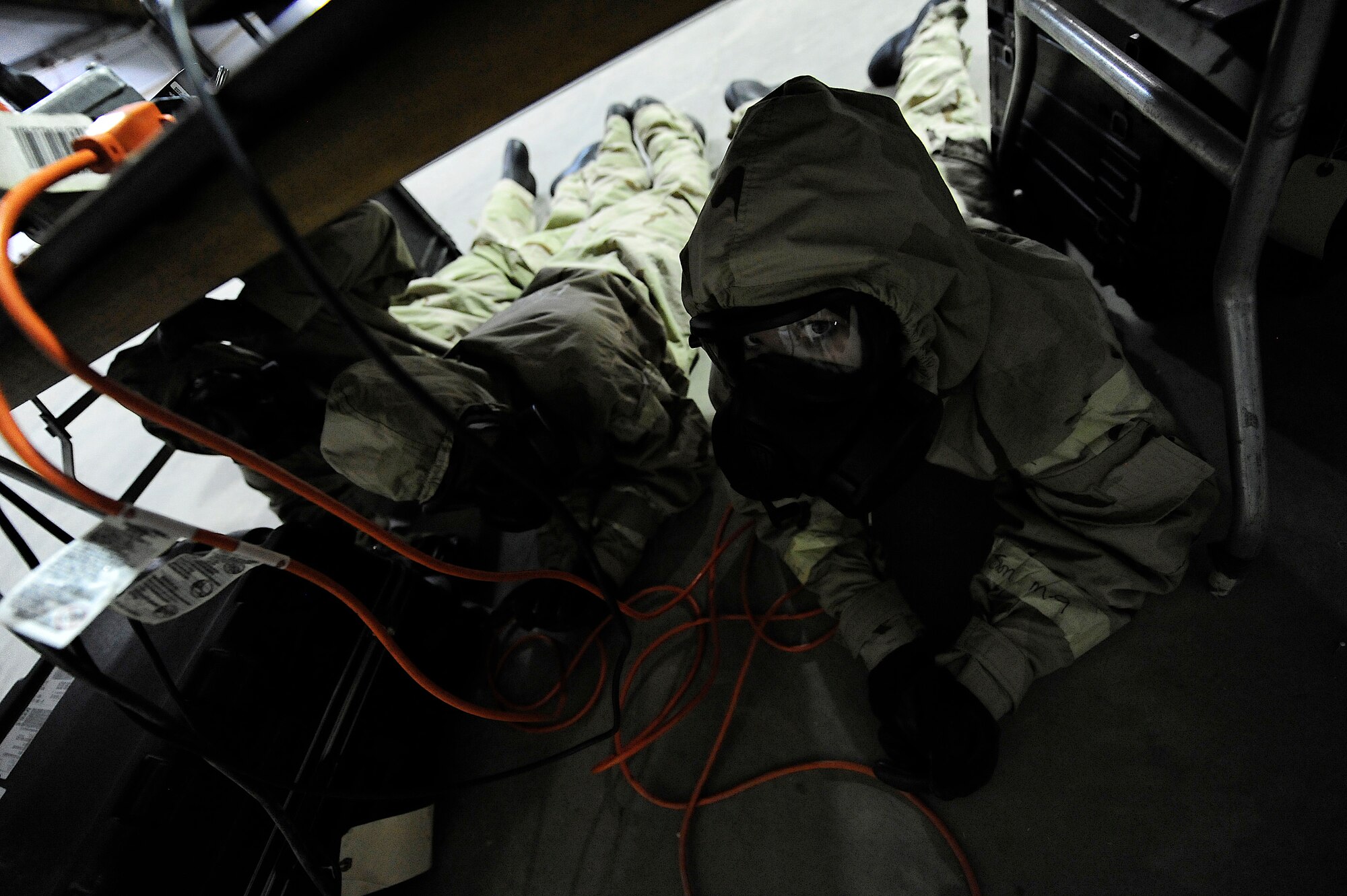 U.S. Air Force Airman 1st Class Sierra Read, 1st Special Operations Aerospace Medicine Squadron, takes cover during a chemical, biological, radiological and nuclear training scenario, Hurlburt Field, Fla., June 14, 2011. The Air Force Special Operations Command developed a training workshop, June 14- 15, to improve the skills of three biological environmental engineers and two civil engineer emergency managers who will represent AFSOC at an Air Force-level CBRN challenge.  (U.S. Air Force photo by Staff Sgt. Julianne M. Showalter/Released)
