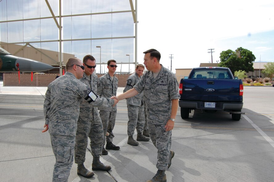 (Left) Tech. Sgt. Sean Minnick, 926th Aircraft Maintenance Squadron weapons loader, greets Brig. Gen. Gary Blaszkiewicz, Director of Logistics, Headquarters Air Force Reserve Command, Robins Air Force Base, Ga., here June 17. General Blaszkiewicz visited the F-16 Viper aircraft maintenance unit to talk with reservists integrated with the active duty force at Nellis. Reservists in the 926th AMXS, like Sergeant Minnick and the other members pictured, provide additional manpower and expertise to the active duty's 57th Maintenance Group here. 