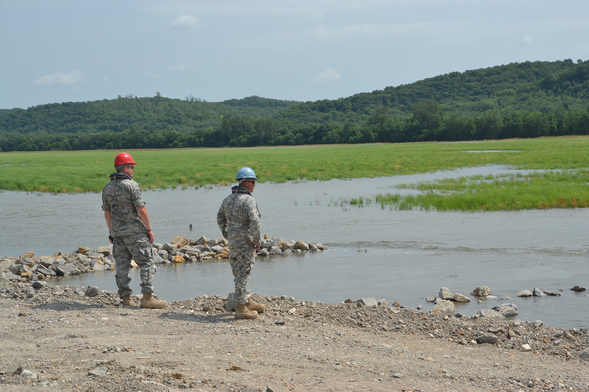 An airman from the Missouri Air National Guard and a soldier from the Kansas National Guard drive along federal levee 471-460-R near St. Joseph, Mo., June 20, 2011. The Missouri and Kansas National Guards are providing joint levee patrol on an approximately 10 mile stretch along the Missouri River. (U.S. Air Force photo by Staff Sgt. Michael Crane)