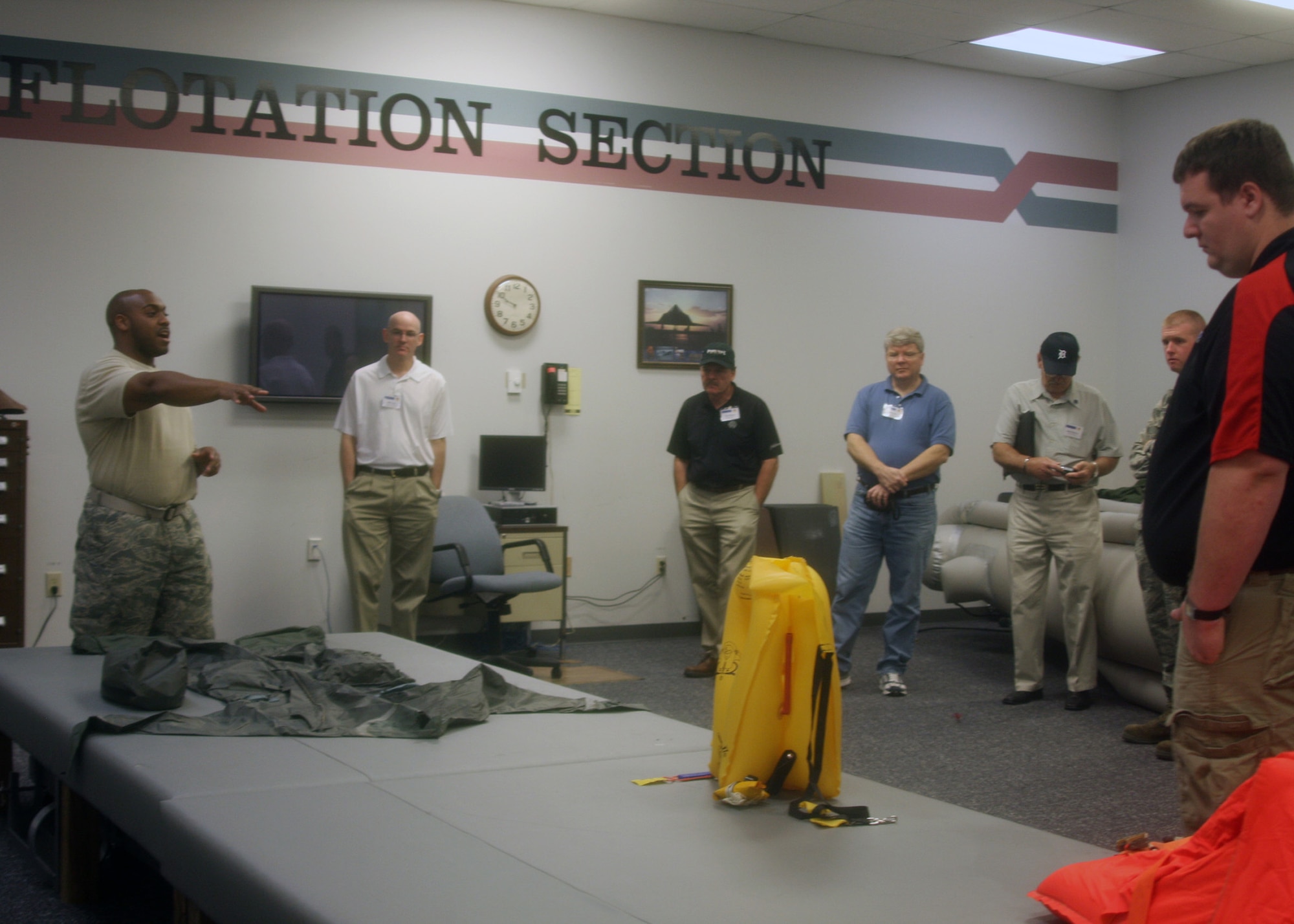 WRIGHT-PATTERSON AIR FORCE BASE, Ohio - Staff Sgt. De’Juan Gaskins, Sr., 445th Operations Support Squadron aircrew flight equipment technician, explains the various survival equipment his section is responsible for during the wing’s annual Employer Appreciation Day June 4. (U.S. Air Force photo/Tech. Sgt. Julie Weckerlein)