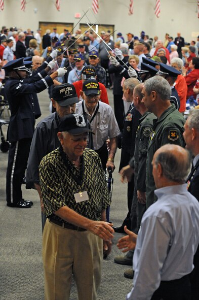 Veterans pass through a saber cordon during the Prisoner of War/ Missing in Action parade of heroes on Barksdale Air Force Base, La., June 17. The veterans were greeted by Lt. Gen. Jim Kowalski, Air Force Global Strike Command commander, Brig. Gen. Stephen Wilson, Eighth Air Force commander, Brig. Gen. John Mooney III, 307th Bomb Wing commander, Col. Tim Fay, 2nd Bomb Wing commander, and Lorenz Walker, Bossier City mayor, as they walked through the cordon. The luncheon was held to honor all POWs and MIA Soldiers, Sailors, Airmen and Marines. (U.S. Air Force photo/Airman 1st Class Micaiah Anthony)(RELEASED)
