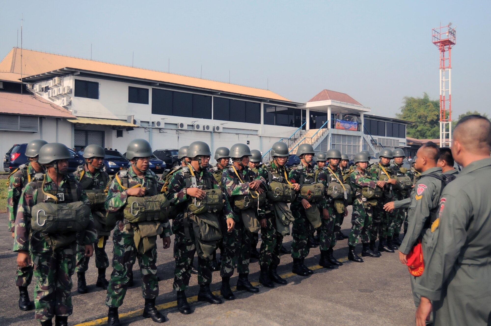HALIM AIR BASE, Indonesia -- Indonesian paratroopers prepare to board a C-130 Hercules from the 36th Airlift Squadron at Yokota Air Base, Japan, prior to thier first mission in Exercise Cope West 11 at Halim Air Base, Indonesia, June 20, 2011. The combined training offered by this exercise will help prepare U.S. and Indonesian Air Forces to work together in promoting a peaceful Pacific region. (U.S. Air Force photo/Capt. Raymond Geoffroy)