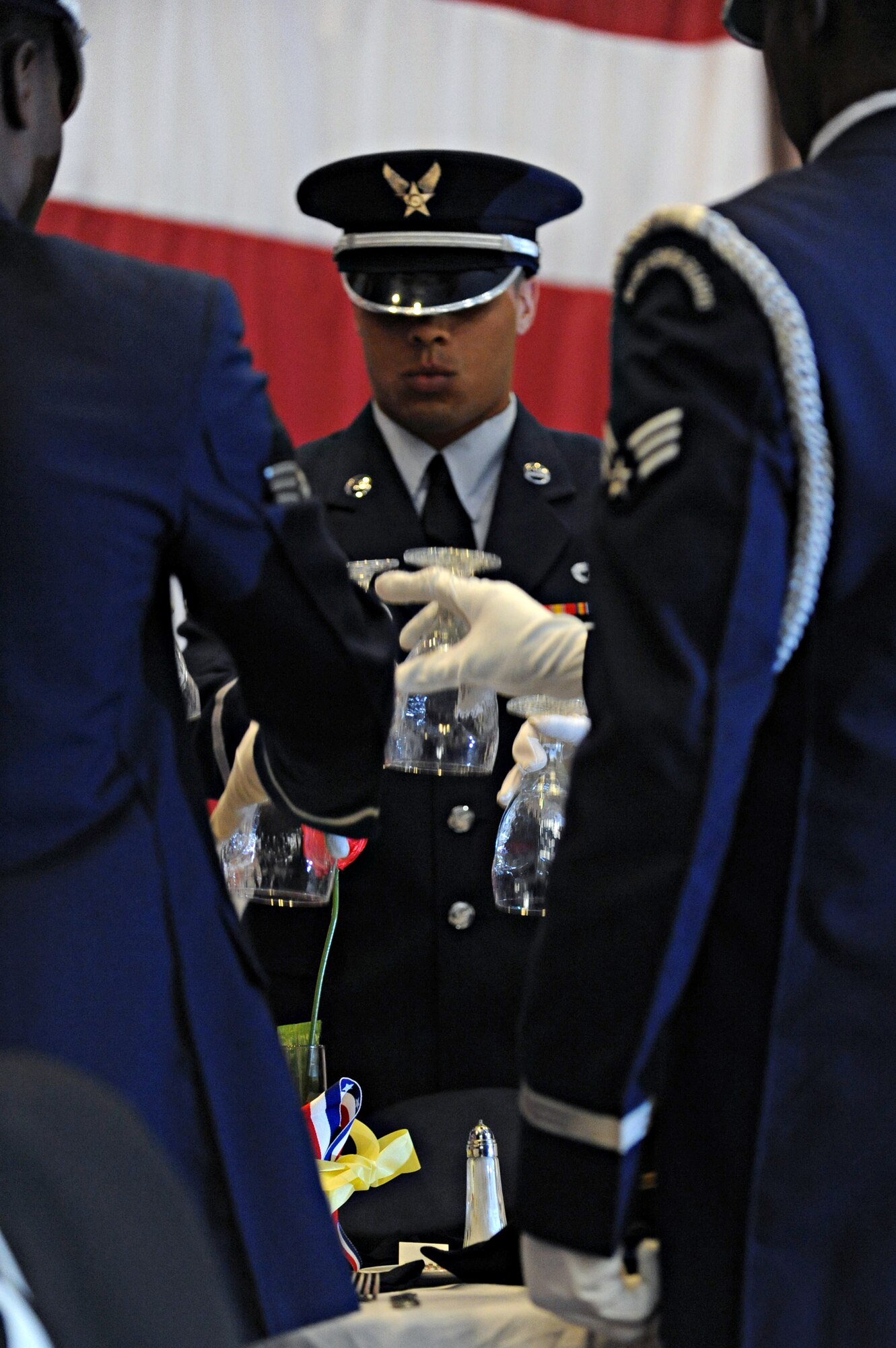 Airmen from the Barksdale honor guard invert glasses during the Missing in Action ceremony during the Prisoner of War/ Missing in Action Purple Heart Luncheon on Barksdale Air Force Base, La., June 17. The luncheon was held to honor all POWs and MIA Soldiers, Sailors, Airmen and Marines. (U.S. Air Force photo/Airman 1st Class Micaiah Anthony)(RELEASED)