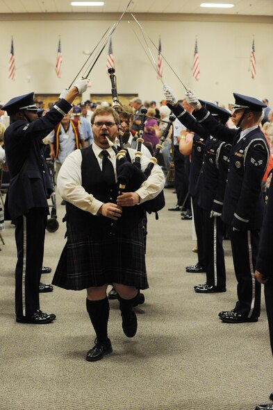 Alfred Barrow, bagpiper, and Seth Barrow, drummer, lead the parade of heroes during the Prisoner of War/ Missing in Action Purple Heart Luncheon on Barksdale Air Force Base, La., June 17. The luncheon was held to honor all POWs and MIA Soldiers, Sailors, Airmen and Marines. (U.S. Air Force photo/Airman 1st Class Micaiah Anthony)(RELEASED)