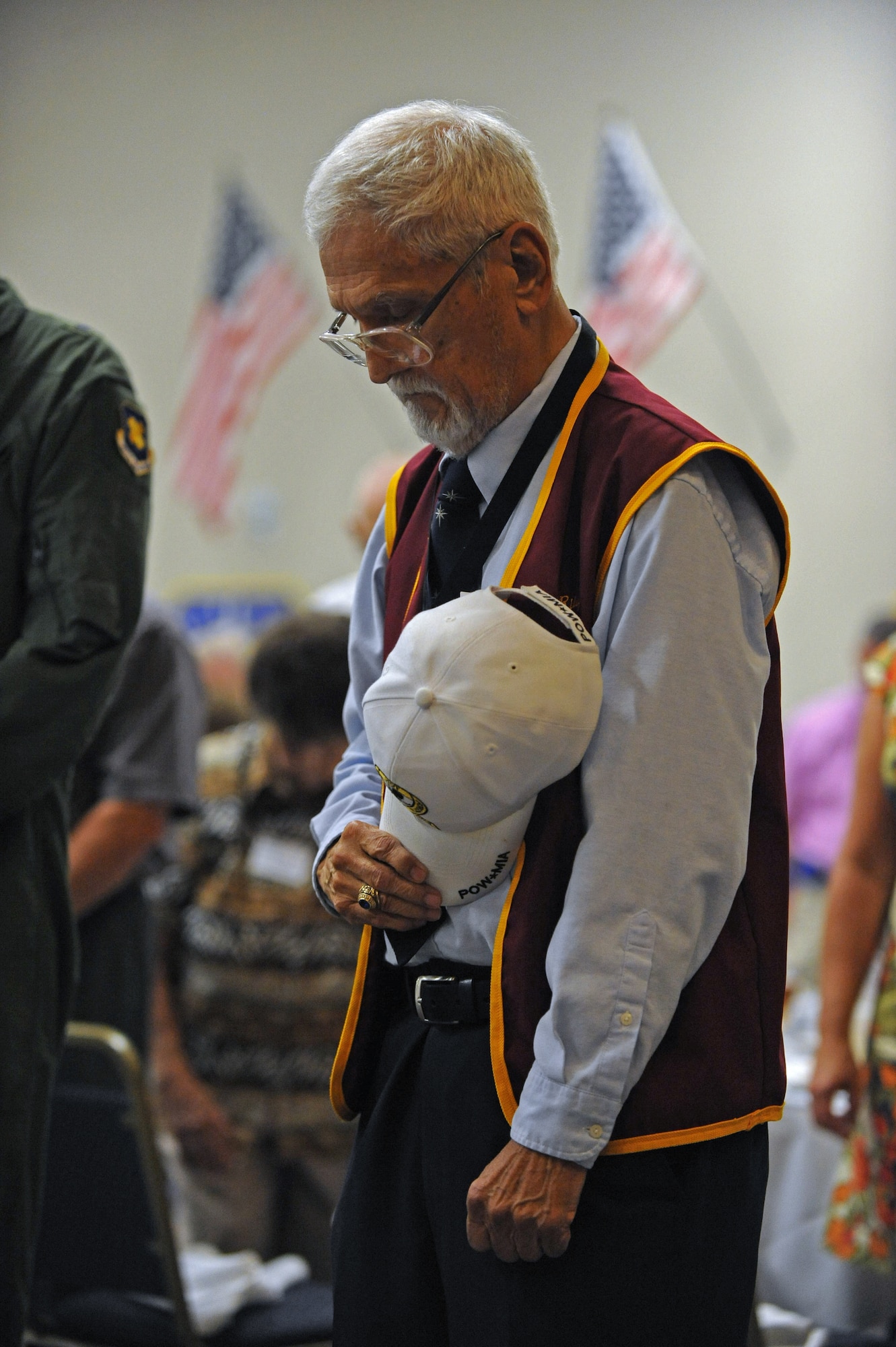 A veteran places his hat over his heart during the invocation of the Prisoner of War/ Missing in Action Purple Heart Luncheon on Barksdale Air Force Base, La., June 17. The luncheon was held to honor all POWs and MIA Soldiers, Sailors, Airmen and Marines. (U.S. Air Force photo/Airman 1st Class Micaiah Anthony)(RELEASED)