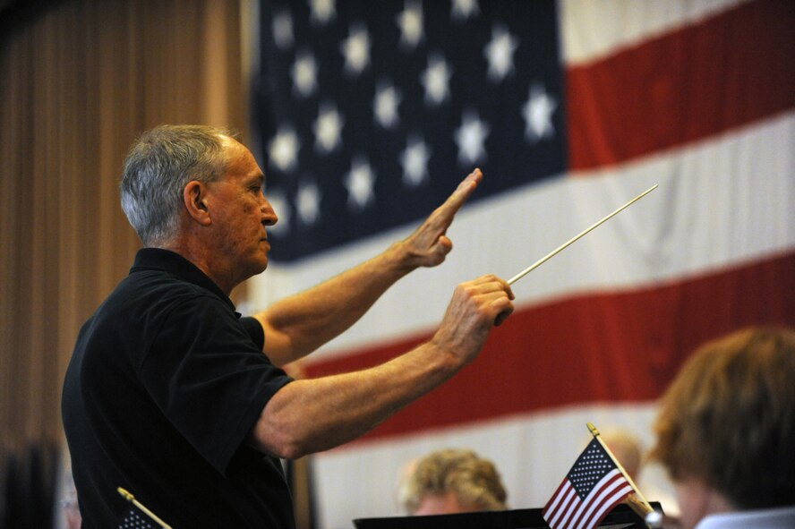 The conductor for the Shreveport Metropolitan Concert Band conducts the band during the Prisoner of War/ Missing in Action Purple Heart Luncheon on Barksdale Air Force Base, La., June 17. The band played a variety of patriotic songs during the luncheon to honor the veterans. (U.S. Air Force photo/Airman 1st Class Micaiah Anthony)(RELEASED)