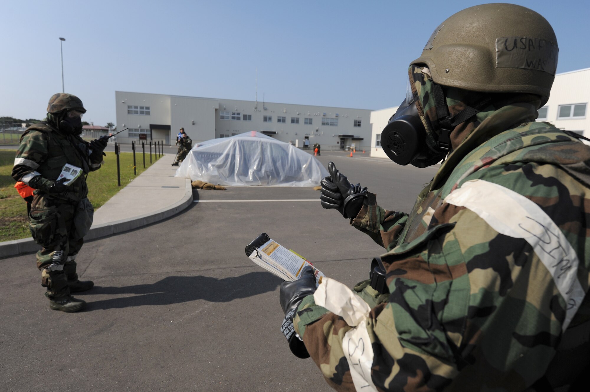 Senior Airman David Washington (right) and Airman 1st Class Eric Jones perform post-attack reconnaissance actions June 20, 2011, during a training exercise at Misawa Air Base, Japan. Both Airmen are assigned to 35th Civil Engineer Squadron. (U.S. Air Force photo/Staff Sgt. April Quintanilla)