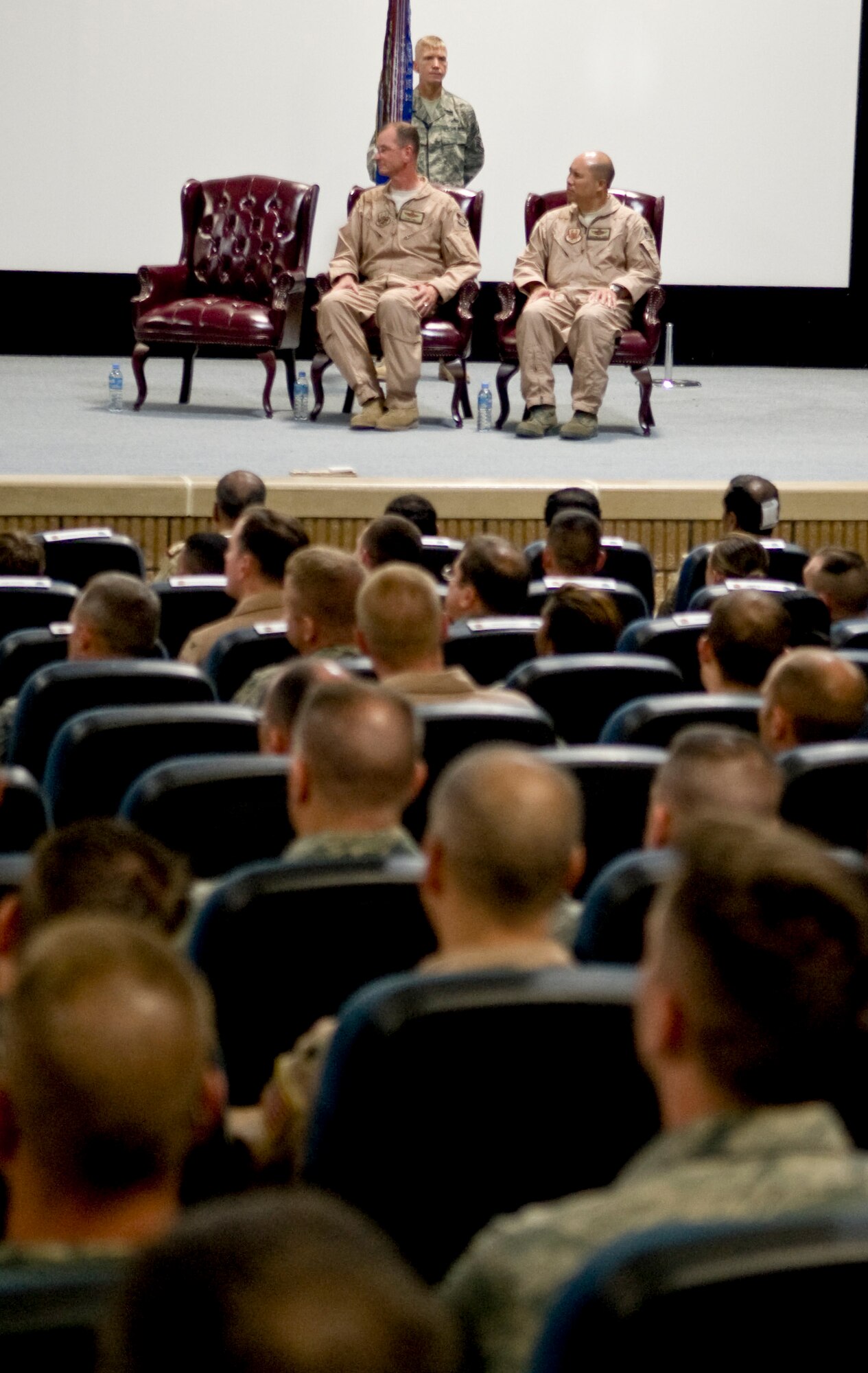 Col. Giovanni K. Tuck, 379th Air Expeditionary Wing commander, sits next to Brig. Gen. Randy A. Kee during the 379th AEW change of command June 20. Colonel Tuck assumed command from Brig. Gen. Randy A. Kee. (U.S. Air Force photo/Senior Airman Paul Labbe)