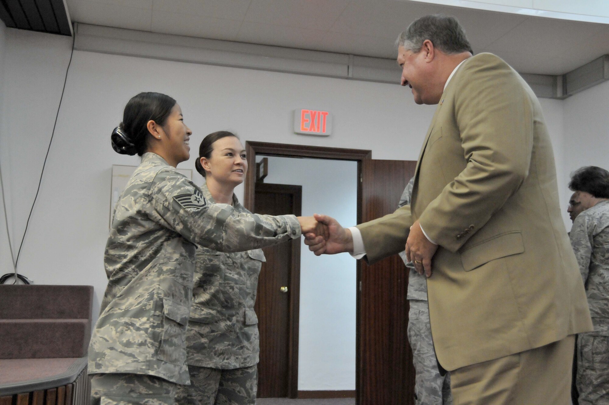 Secretary of the Air Force Michael Donley thanks Staff Sgts. Kaythi Saw and Patricia Harvey June 17, 2011, for their service to the Air Force. Sergeants Saw and Harvey are assigned to the 52nd Force Support Squadron. (U.S. Air Force photo/Capt. John P. Capra)