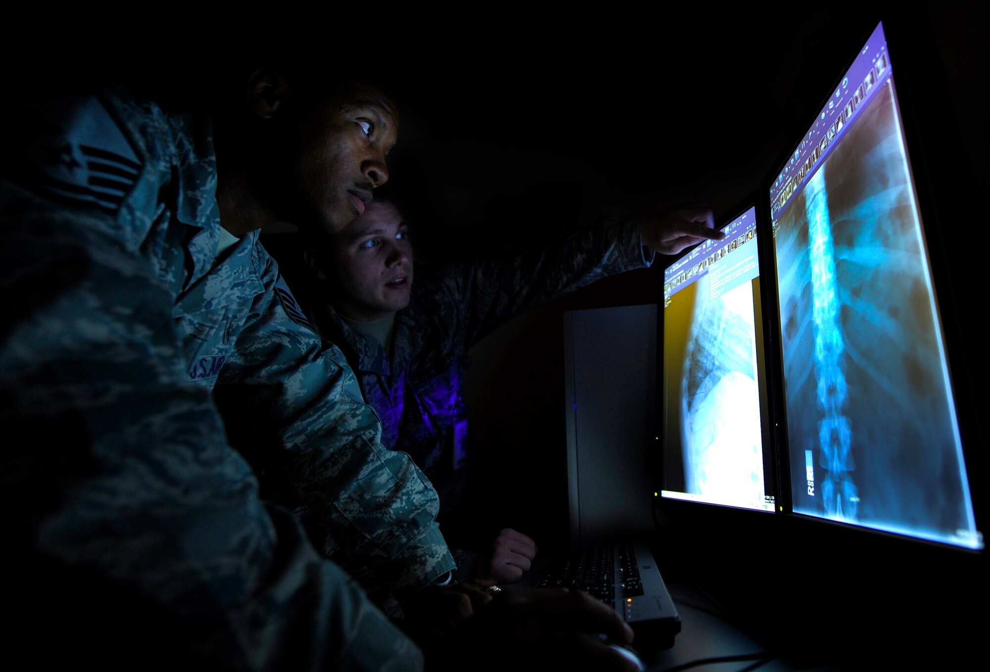 Master Sgt. Danyell Gardner, 20th Medical Support Squadron diagnostics technician flight chief, and Staff Sgt. David Yarnell 20th MDSS diagnostics technician, view patients x-rays on a new McKesson-Pacs x-ray viewing system June 15, 2011. Shaw is among the first bases to have the new system installed. The new x-ray program will help cut down on the amount of wasted film and CDs, which will save the Air Force several thousands dollars a year. (U.S. Air Force photo by Senior Airman Kenny Holston)(Released)
