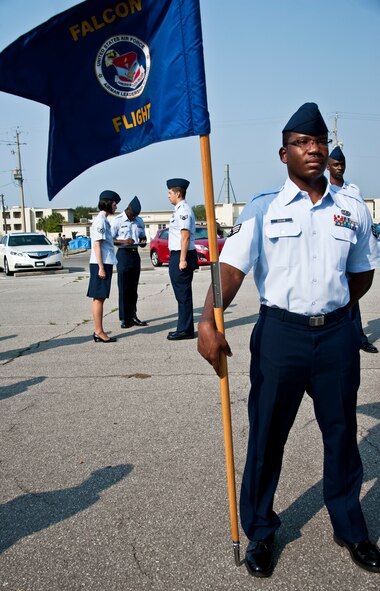 Senior Airman Elton Davis, guidon bearer for Falcon Flight, stands at parade-rest while the Airman Leadership School instructor finishes her open ranks inspection at Eglin Air Force Base, Fla.  Airman Davis, 96th Force Support Squadron, and 39 others underwent the inspection while attending Eglin’s ALS.  ALS is a five-week-long Air Force program designed to develop Airmen into effective front-line supervisors. It is the first professional military education enlisted Air Force members encounter. Eglin's schoolhouse hosts seven ALS classes per year. Eglin was named Air Force Materiel Command's PME program of the year for 2009 and 2010.  (U.S. Air Force photo/Samuel King Jr.)
