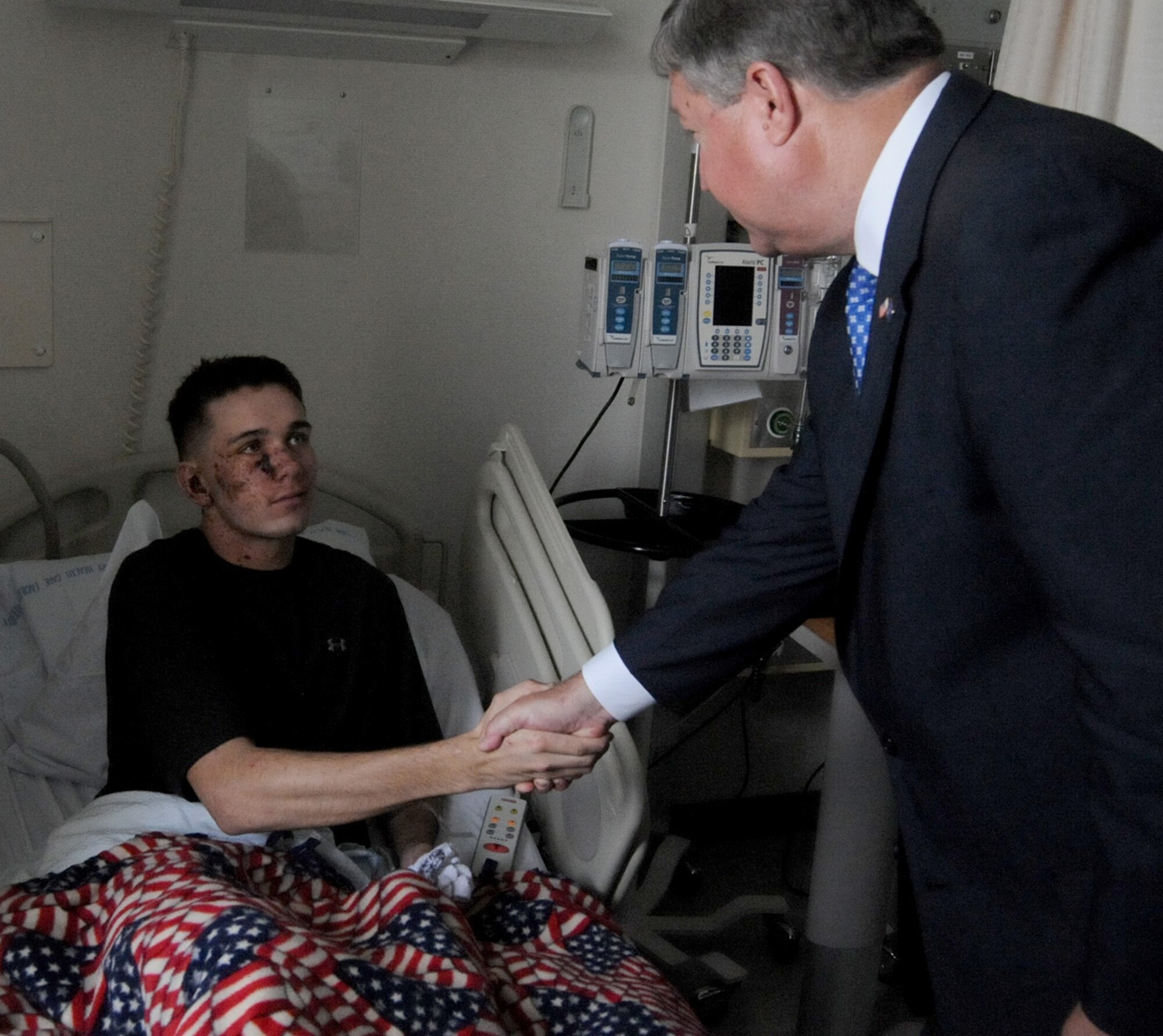 Secretary of the Air Force Michael Donley visits Marine Lance Cpl. Jeremiah Rardin June 18, 2011, at Landstuhl Regional Medical Center, Germany. Lance Corporal Rardin is being treated for injuries sustained while deployed to Afghanistan. (U.S. Army photo/Chuck Roberts)