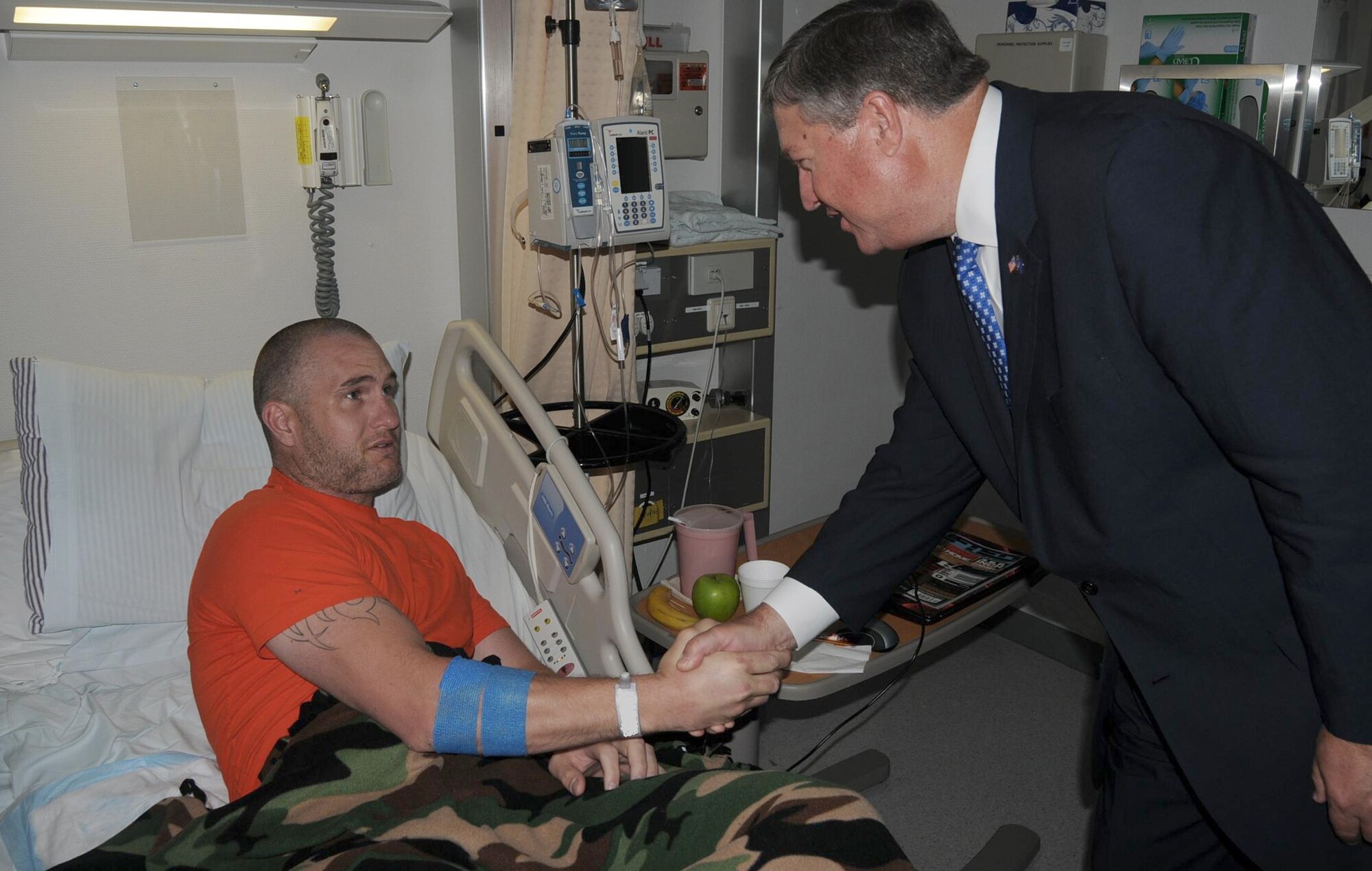 Secretary of the Air Force Michael Donley visits Tech. Sgt. Ryan McGahan June 18, 2011, at Landstuhl Regional Medical Center, Germany. Sergeant McGahan is assigned to the 86th Maintenance Operations Squadron at Ramstein Air Base, Germany. (U.S. Army photo/Chuck Roberts)