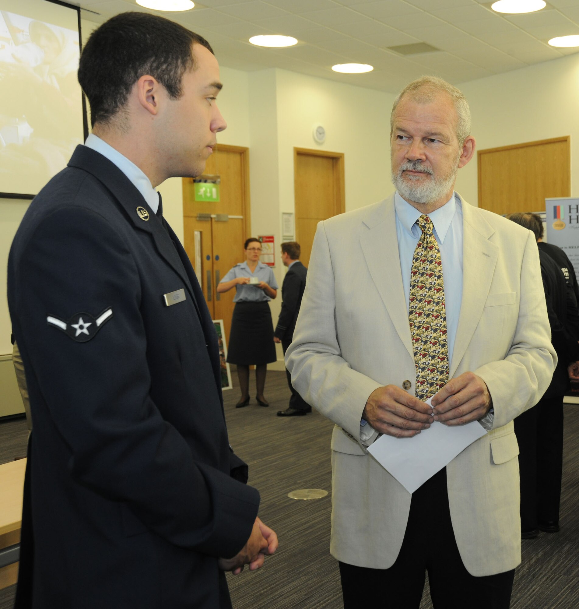 Airman Daniel Legg, 423rd Communications Squadron, speaks with a Huntingdon City Councillor during a U.K. Armed Forces Day event at the Huntingdon District Council June 20.