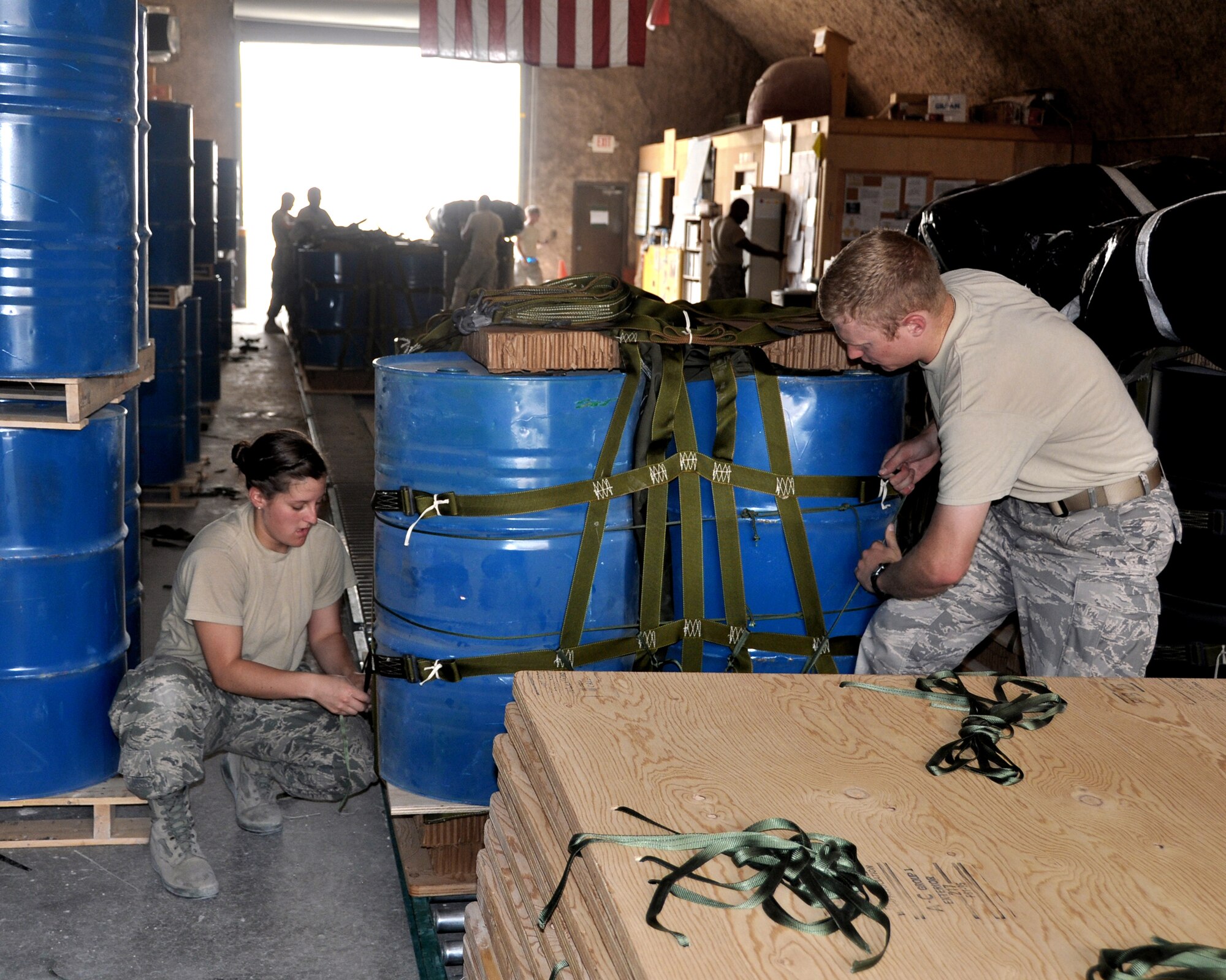 U.S. Air Force Academy Cadet 2nd Class Erin Doran and USAFA Cadet 1st Class Jordan Wittman work together to expedite the bundling process with U.S. Army Riggers June 18, 2011, in Southwest Asia. Cadets Doran and Wittman are taking part in "Deployed Ops", a summer program that sends Academy cadets to deployed locations to follow officers in different career fields and to gain an understanding of career responsibilities. (U.S. Air Force photo/Cadet 1st Class Shaina Thompson)
