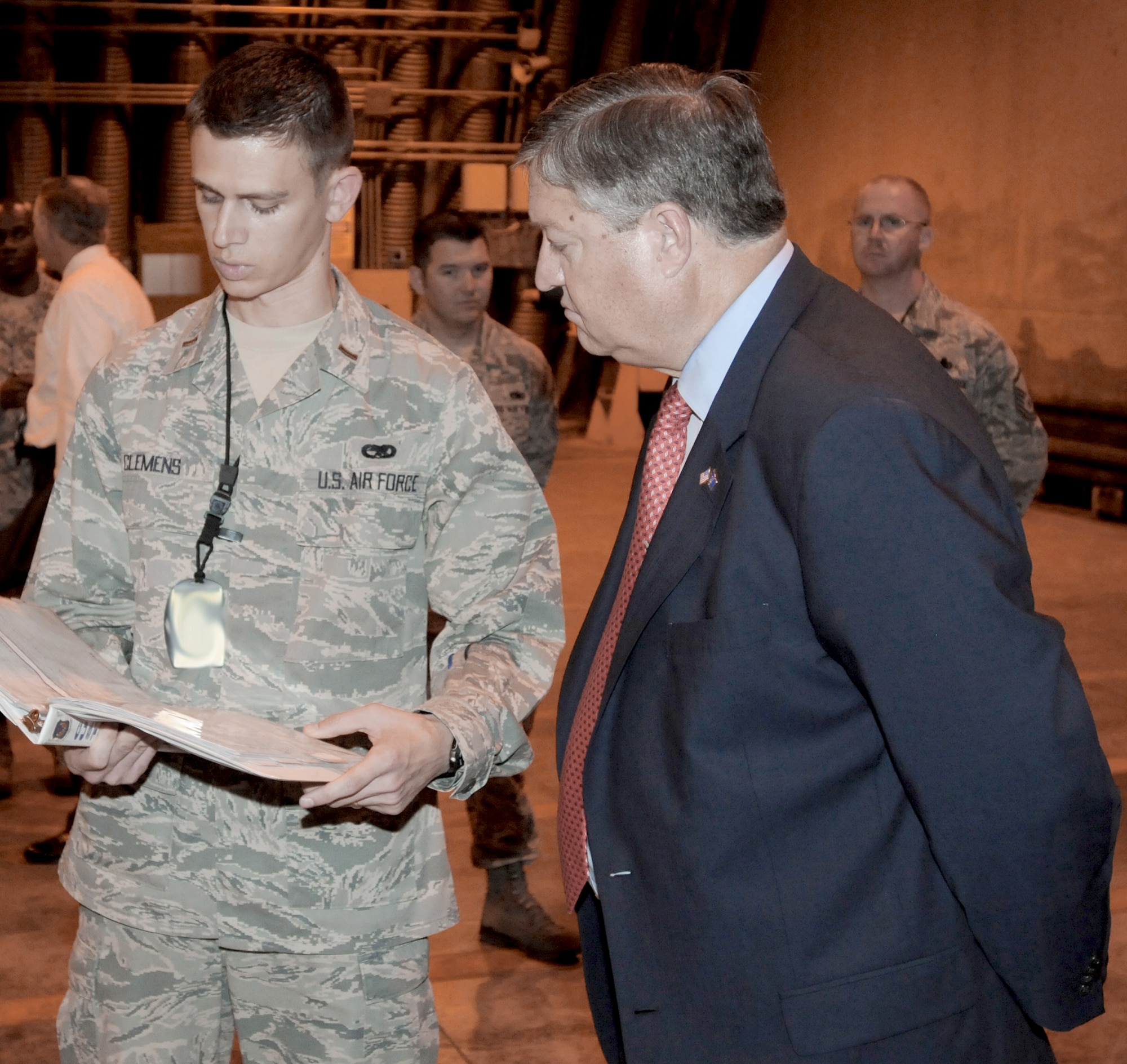 Second Lt. Kyle Clemens briefs Secretary of the Air Force Michael Donley on systems officer duties June 16, 2011, during the secretary's visit to Aviano Air Base, Italy. Lieutenant Clemens is the 31st Munitions Squadron assistant officer in charge of weapons maintenance. (U.S. Air Force photo/Airman LaVel Sterling)