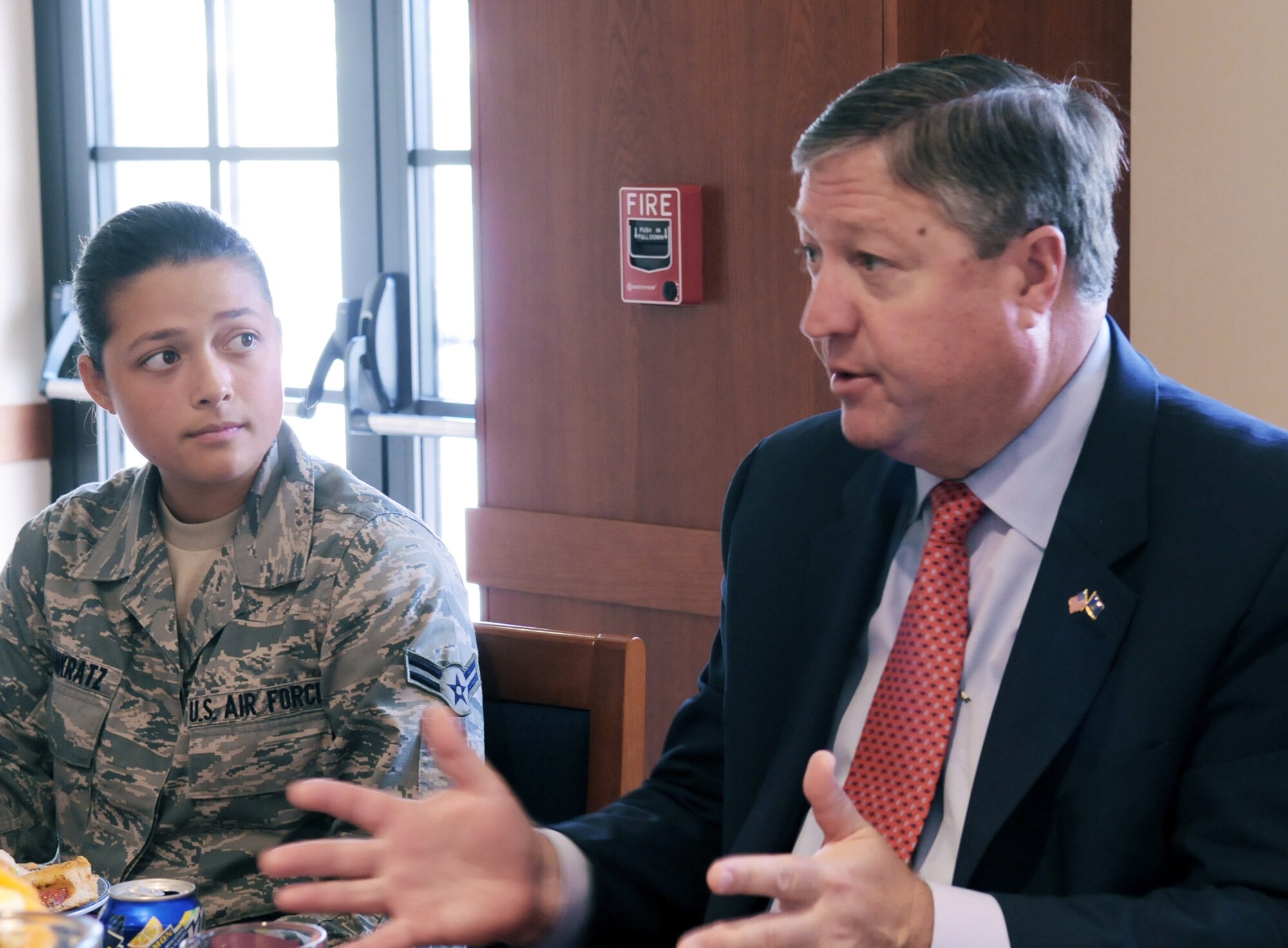 Airman 1st Class Erika Raissa Pankratz listens as Secretary of the Air Force Michael Donley discusses health care and budgetary issues June 16, 2011, during a lunch with Airmen at a dining facility at Aviano Air Base, Italy. Airman Raissa is a 603rd Air Control Squadron surveillance technician. (U.S. Air Force photo/Airman Briana N. Jones)