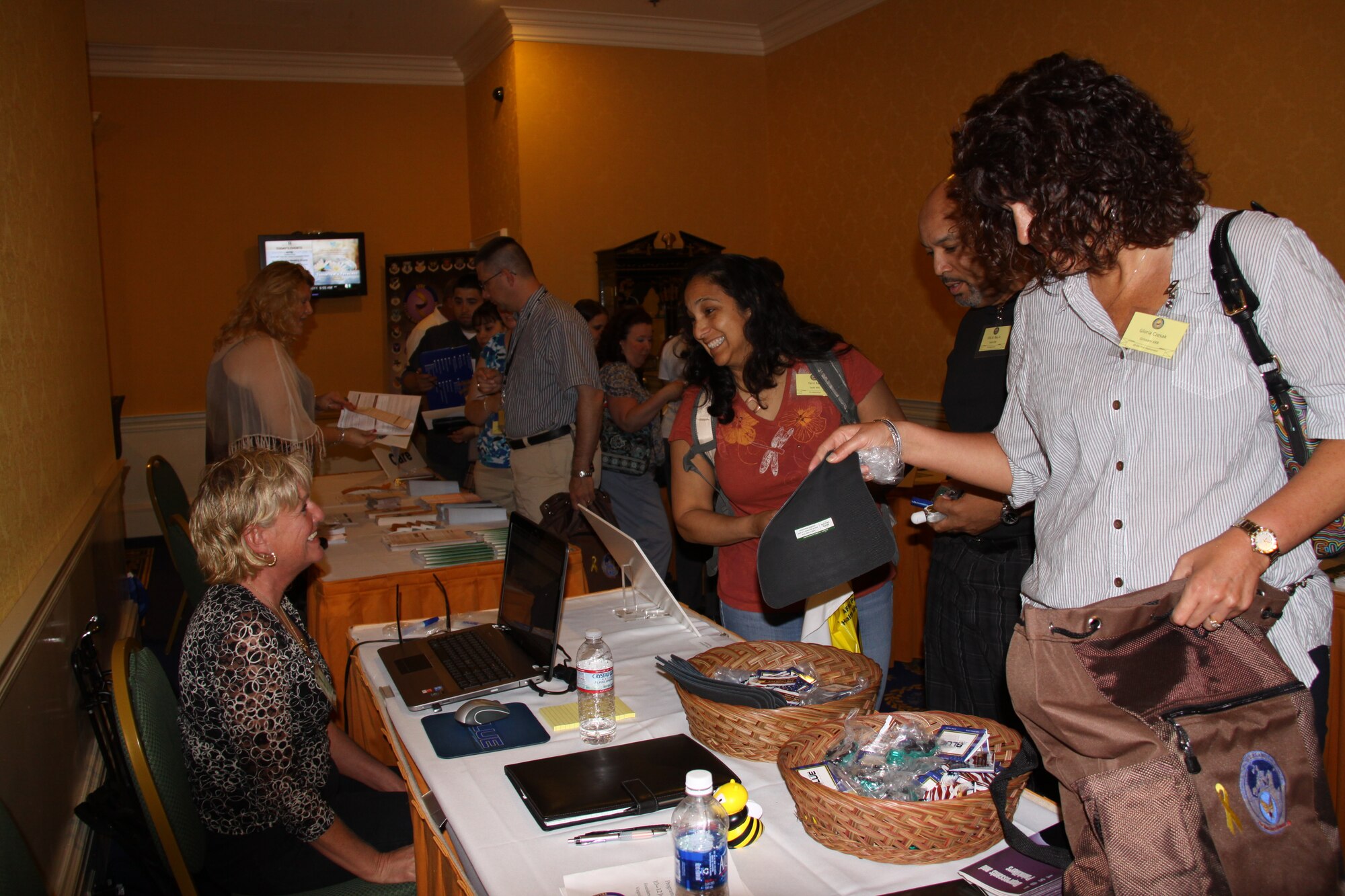 Senior Master Sgt. Diane Douty (seated left), 911th Airlift Wing drug demand reduction specialist, verifies members’ eligibility for enrollment in the Defense Enrollment Eligibility Reporting System, otherwise known as DEERS, during the Yellow Ribbon pre/post-deployment event held June 11-12 in Virginia Beach, Va. The Yellow Ribbon Program is a Department of Defense-wide effort to support National Guard and Reserve service members and families with information on benefits and referrals before, during, and after deployments.  Members will attend an event 90-days prior to deployment, and again upon return at the 30, 60 and 90-day points to help member reintegrate with family and back into civilian life.  More than 300 personnel, from 12 military installations in the Northeast Region, attended the June event.  (U.S. Air Force Photo by Master Sgt. Shannon Hughes)