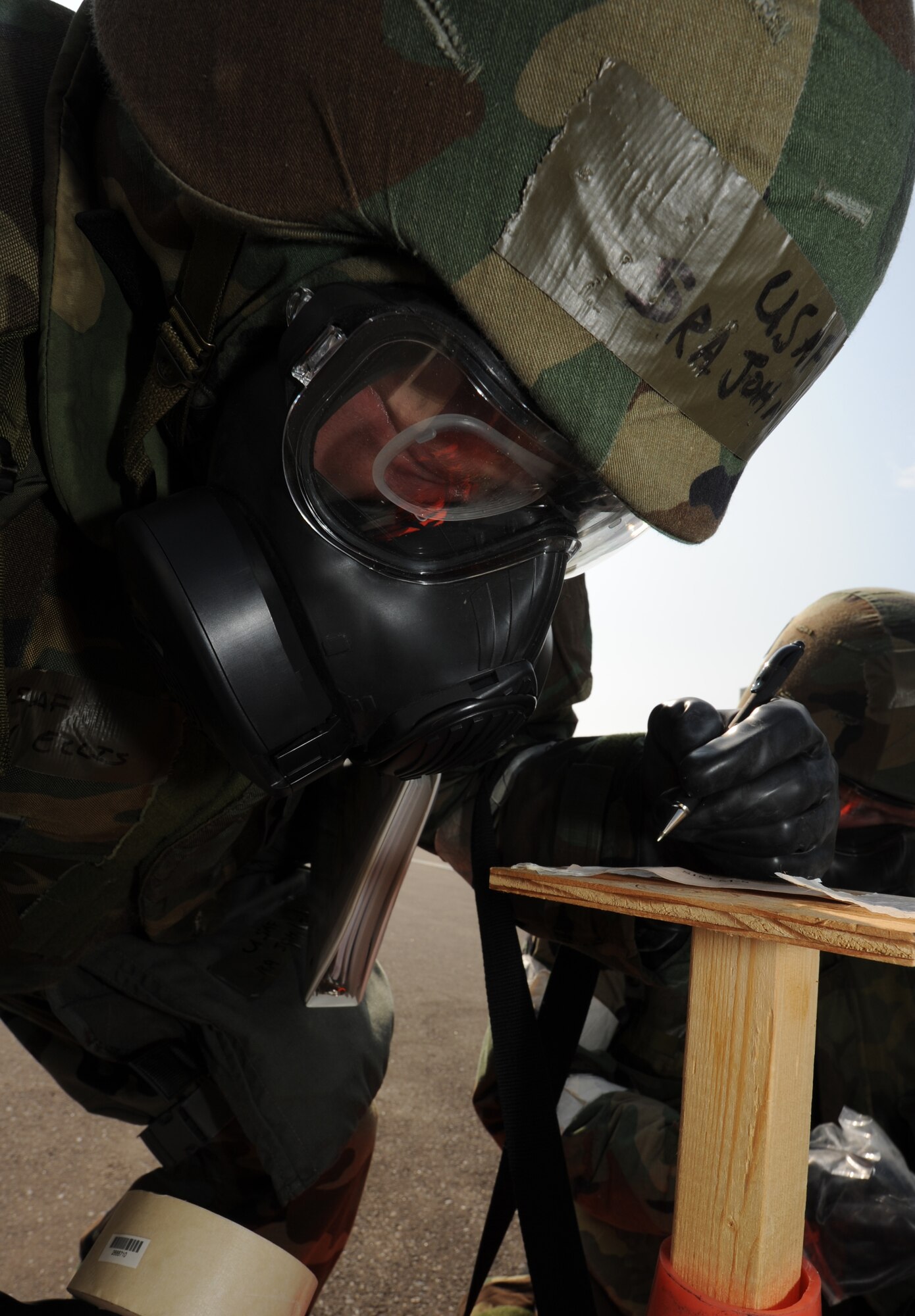 MISAWA AIR BASE, Japan -- Senior Airman John Ellis, 35th Civil Engineer Squadron  post attack reconnaissance team member, replaces contamination detection paper on a stanchion during a training exercise June 20.  During the exercise, PAR teams check for contamination and damage following simulated attacks to the base.  (U.S. Air Force photo/Staff Sgt. April Quintanilla)