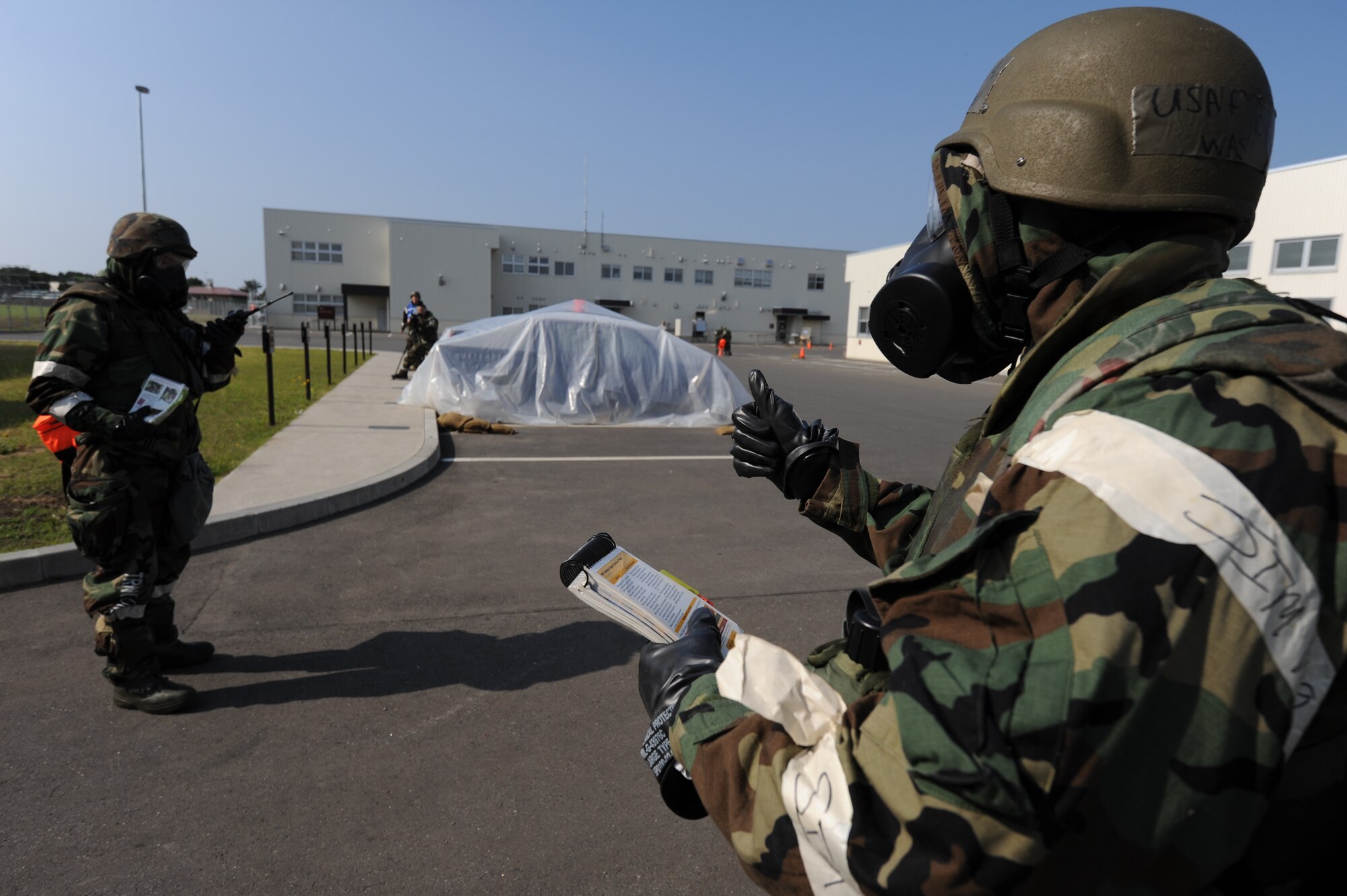 MISAWA AIR BASE, Japan -- Senior Airman David Washington (right), and Airman 1st Class Eric Jones, both from the 35th Civil Engineer Squadron, perform post attack reconnaisance actions during a training exercise June 20.  Airmen at Misawa are participating in a week-long exercise designed to test their ability to survive and operate in a combat environment. (U.S. Air Force photo/Staff Sgt. April Quintanilla)