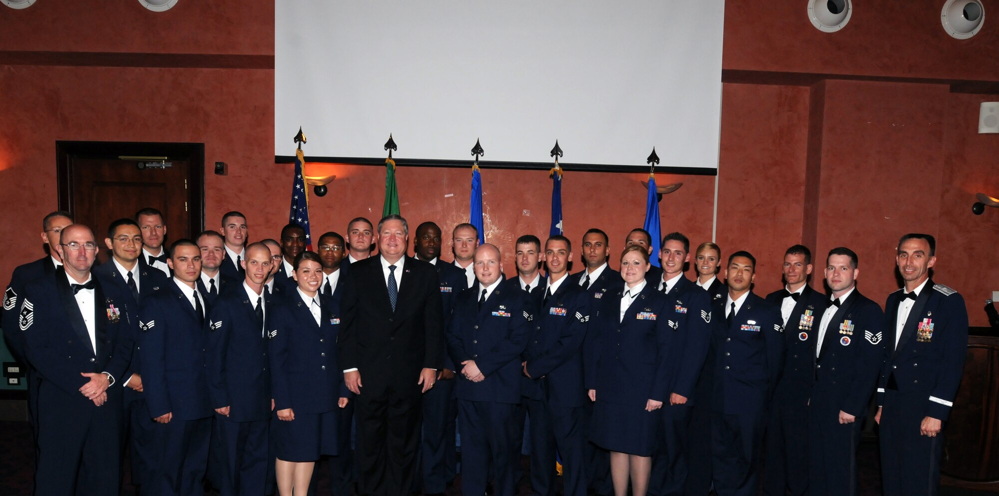 Chief Master Sgt. Jeff Craver (front left), 31st Fighter Wing command chief, Secretary of the Air Force Michael Donley (center), and Brig. Gen. Scott J. Zobrist (far right), 31st Fighter Wing commander, stand with graduates and faculty of the Aviano Air Base Airman Leadership School during a graduation ceremony at La Bella Vista Club, Aviano Air Base, Italy, June 16, 2011. (U.S. Air Force photo/Airman LaVel Sterling)