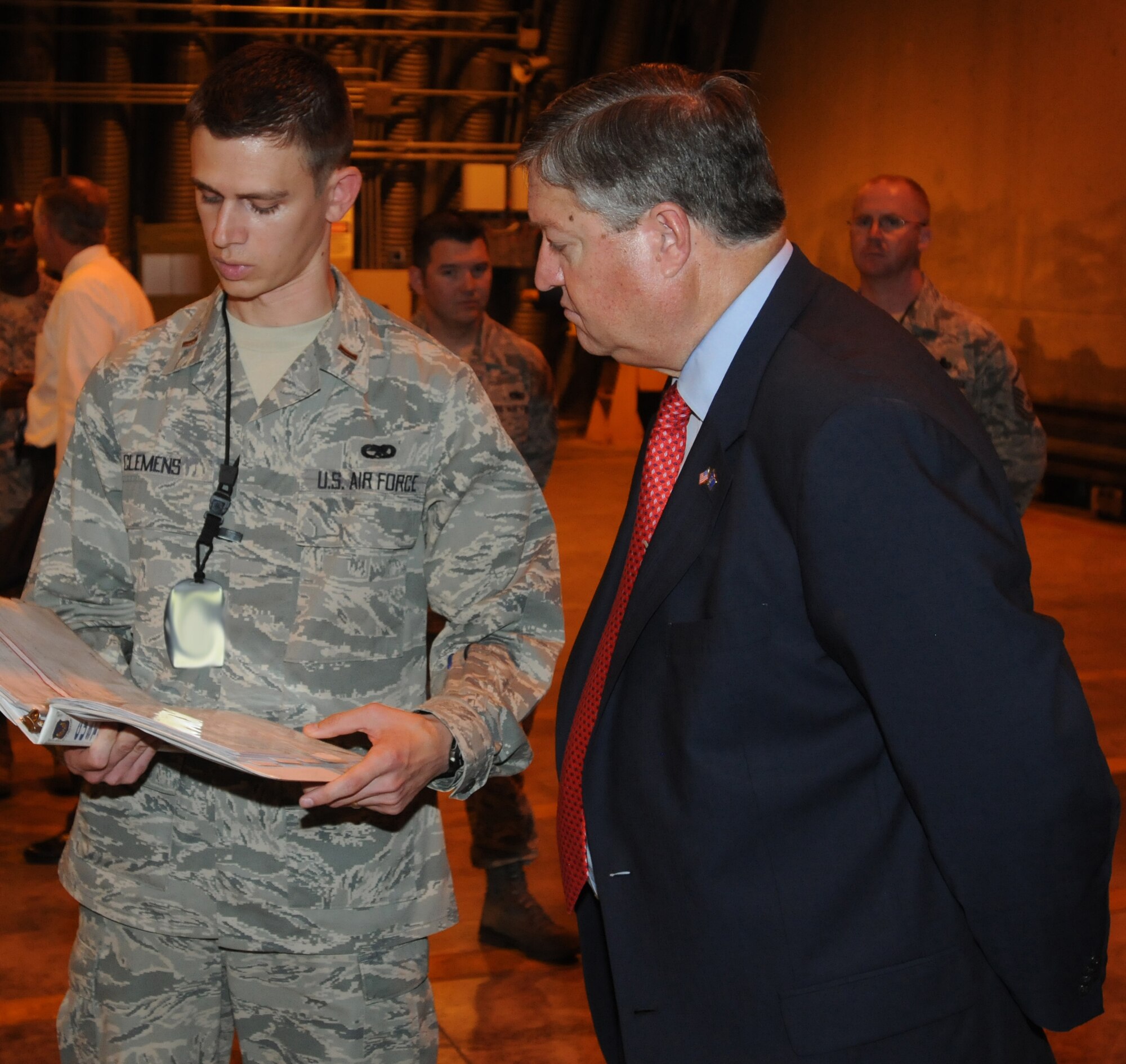 2nd Lt. Kyle Clemens, 31st Munitions Squadron assistant officer in charge of weapons maintenance, briefs Secretary of the Air Force Michael Donley on systems officer duties during the secretary’s visit to Aviano Air Base, Italy, June 16, 2011. (U.S. Air Force photo/Airman LaVel Sterling)